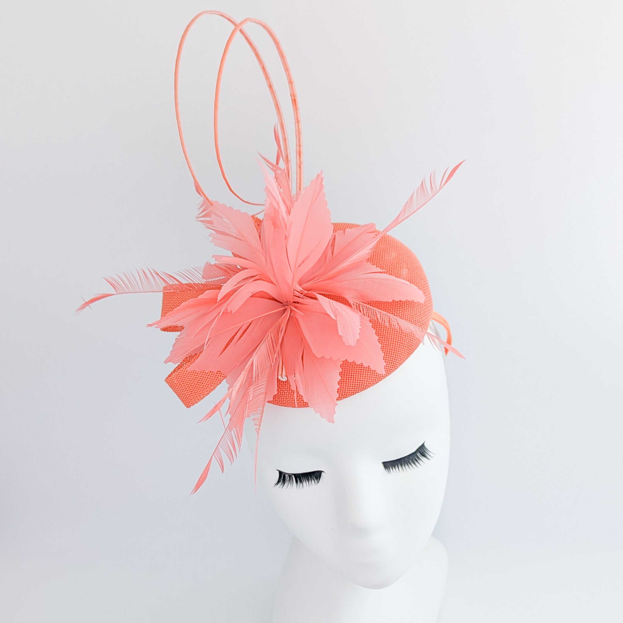 Coral orange feather fascinator hat Coral orange feather fascinator hat