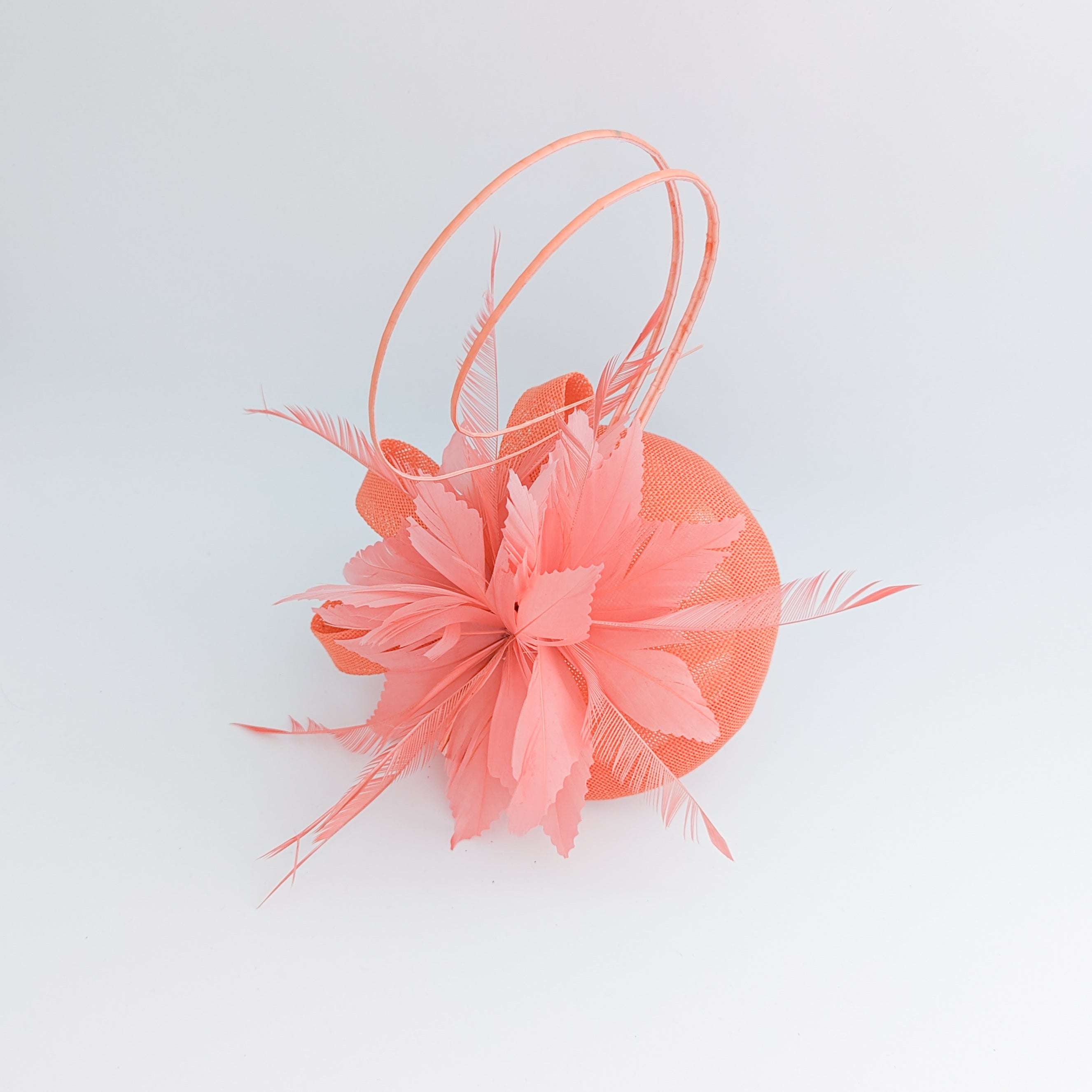 Coral orange feather fascinator hat Coral orange feather fascinator hat