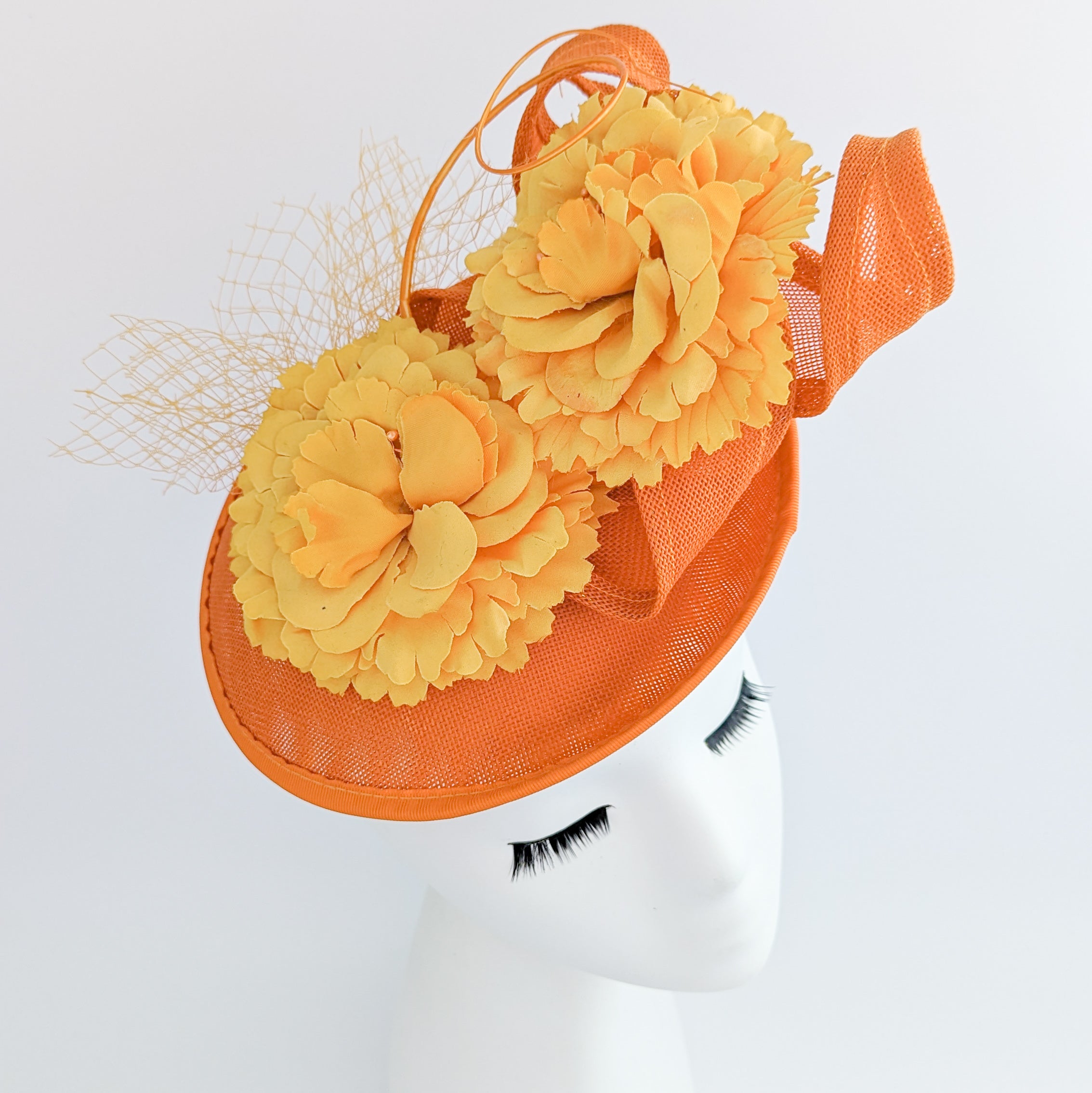 Orange flower fascinator disc saucer hat Orange flower fascinator disc saucer hat