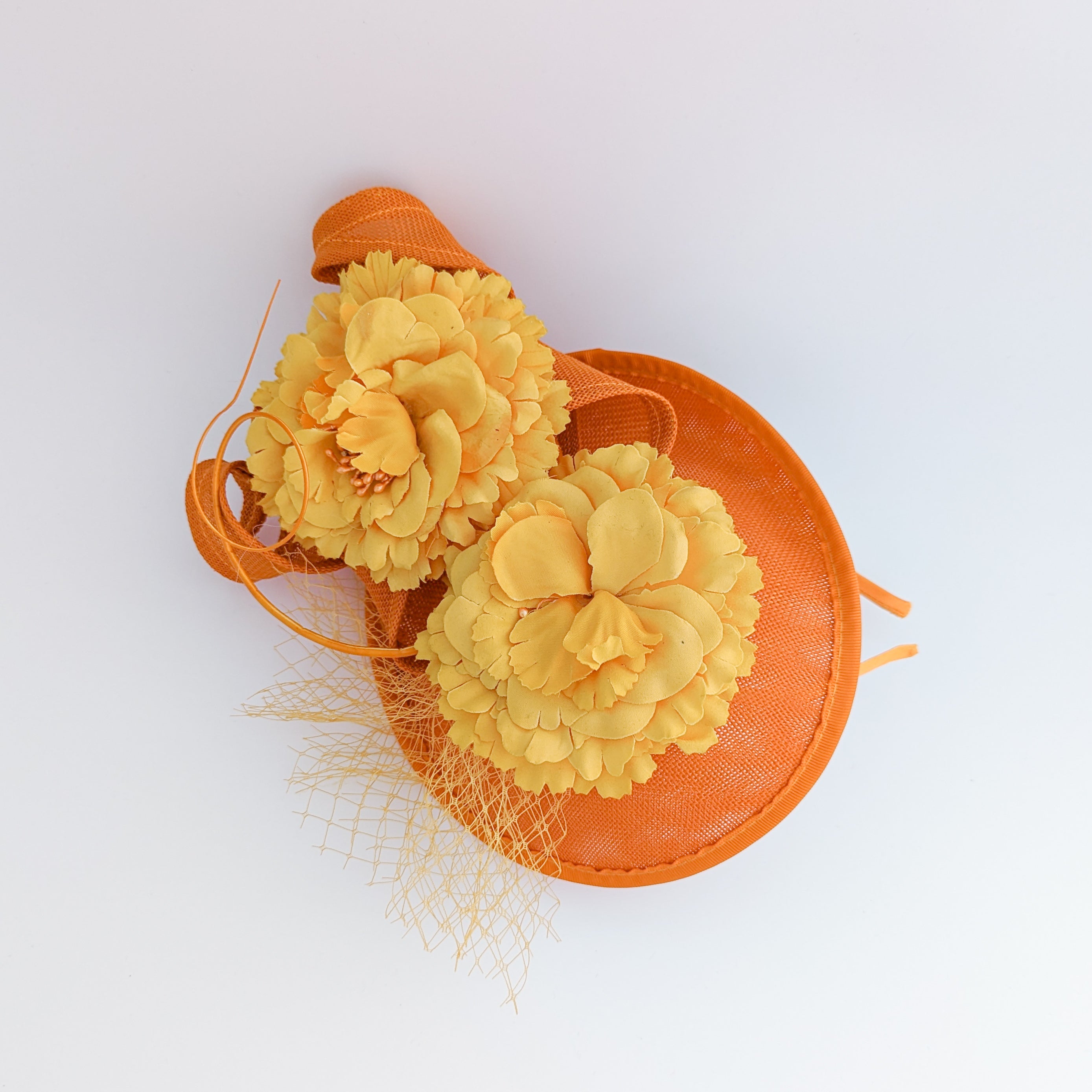 Orange flower fascinator disc saucer hat Orange flower fascinator disc saucer hat