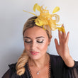 Yellow feather fascinator hat