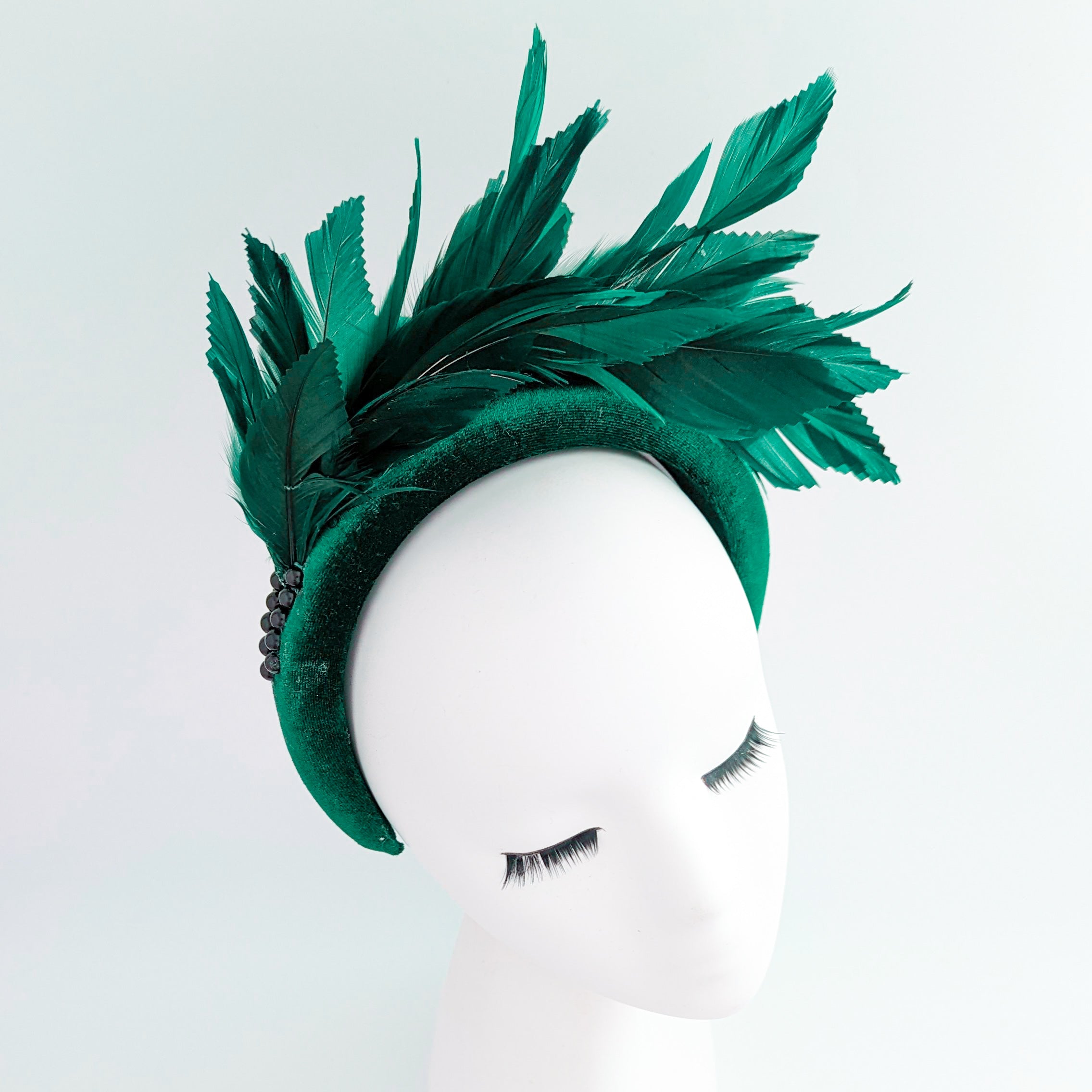 Dark emerald green feather padded velvet headband fascinator