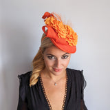 Orange flower fascinator disc saucer hat Orange flower fascinator disc saucer hat