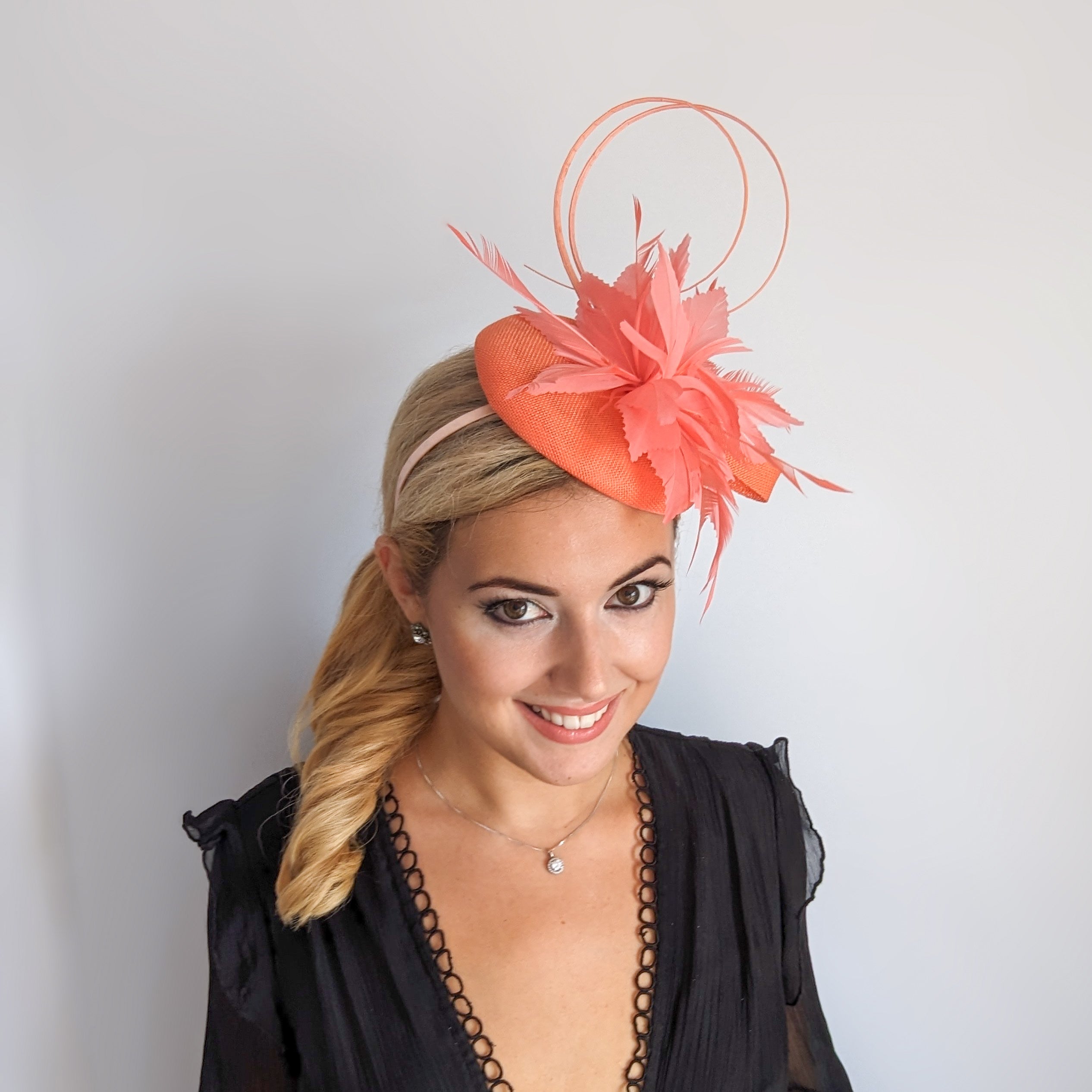 Coral orange feather fascinator hat