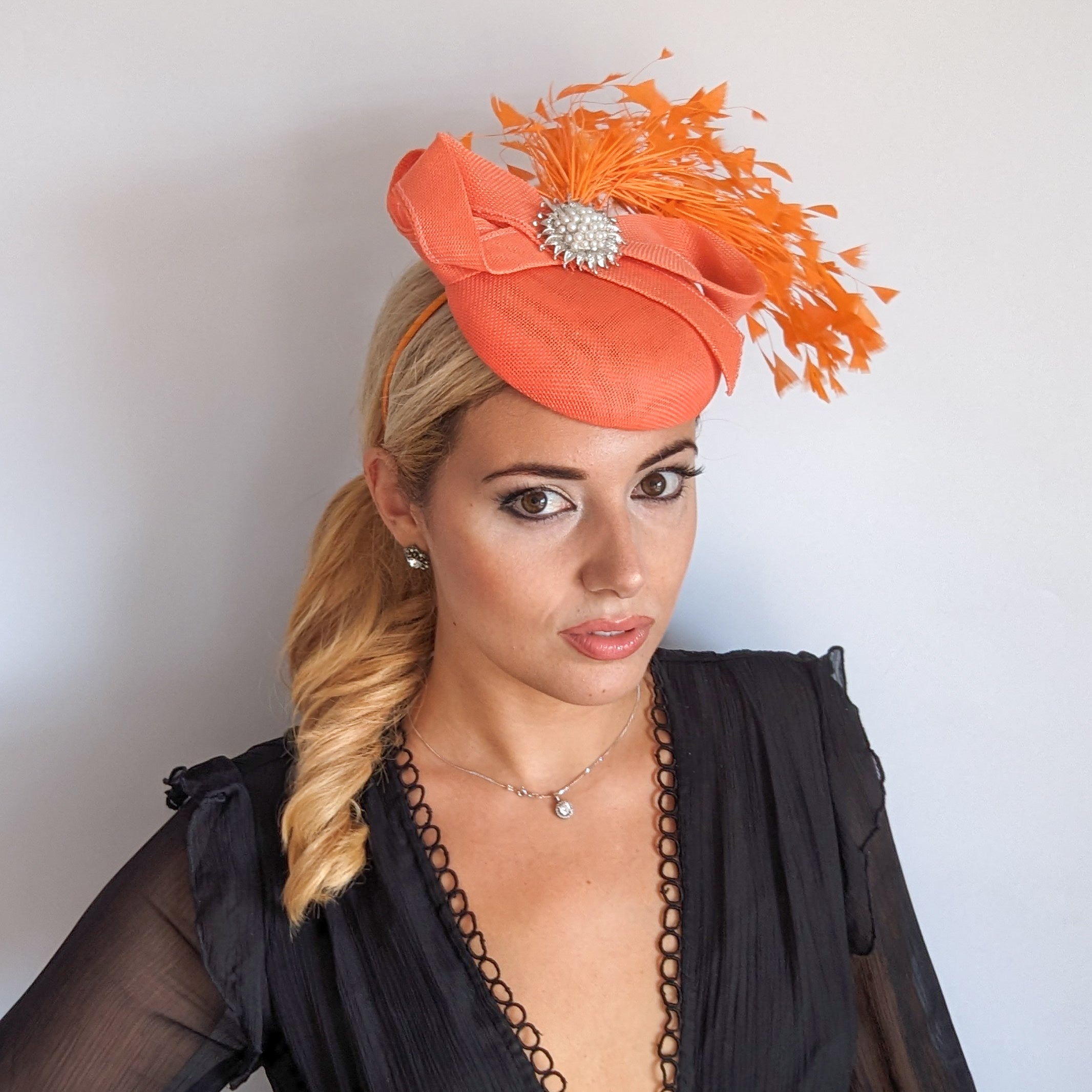 Coral orange feather pearl fascinator hat Coral orange feather pearl fascinator hat