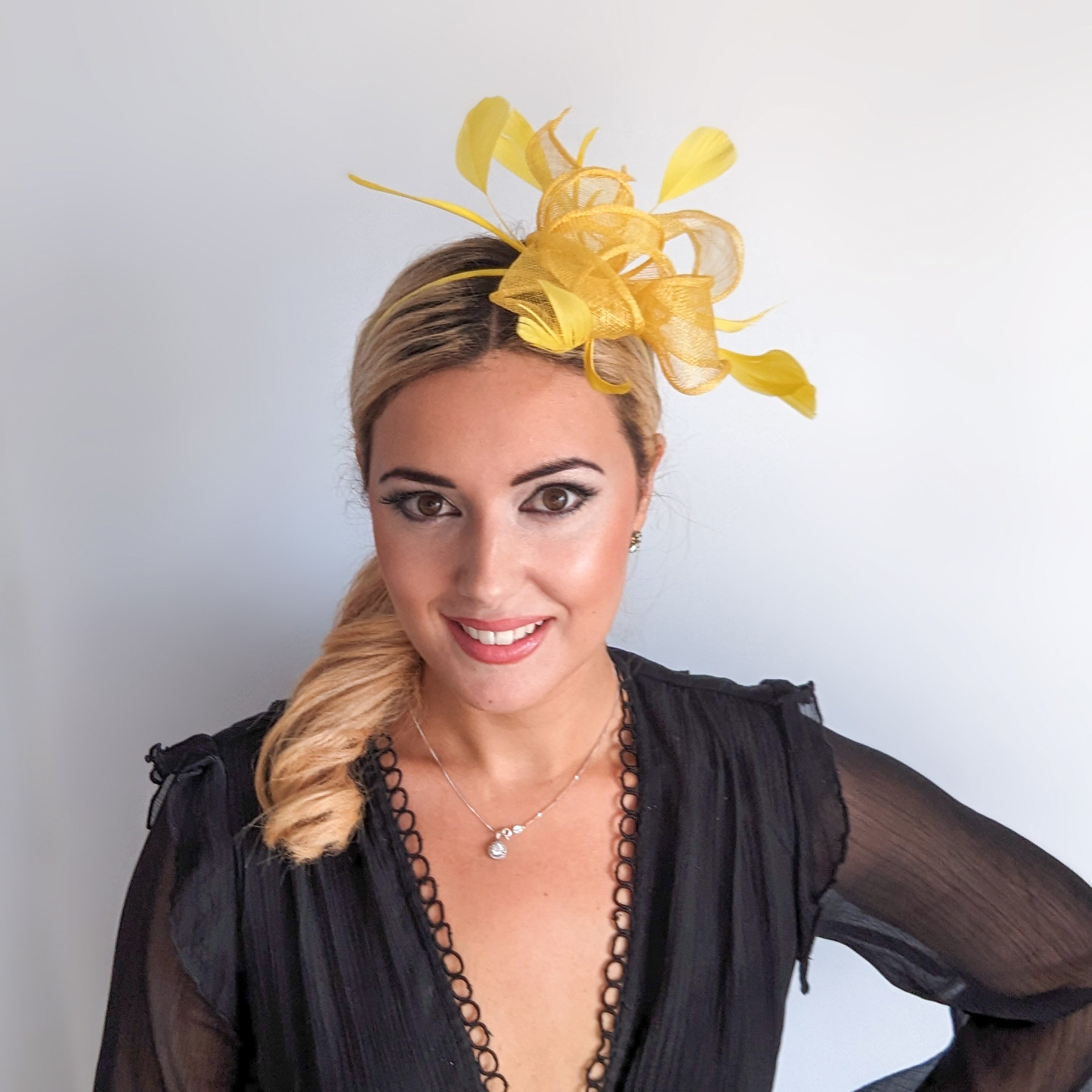 Yellow feather fascinator hat