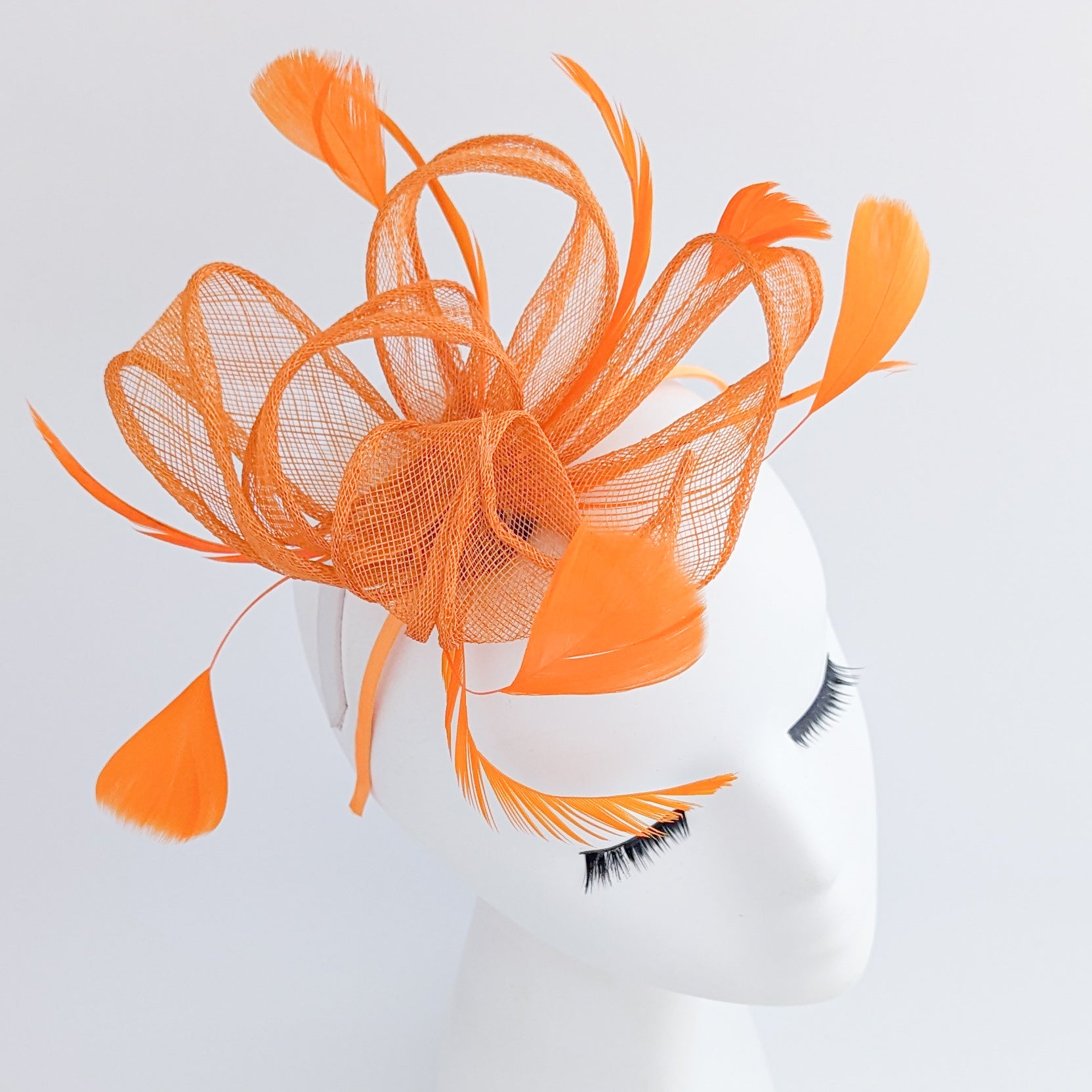 Orange feather fascinator hat