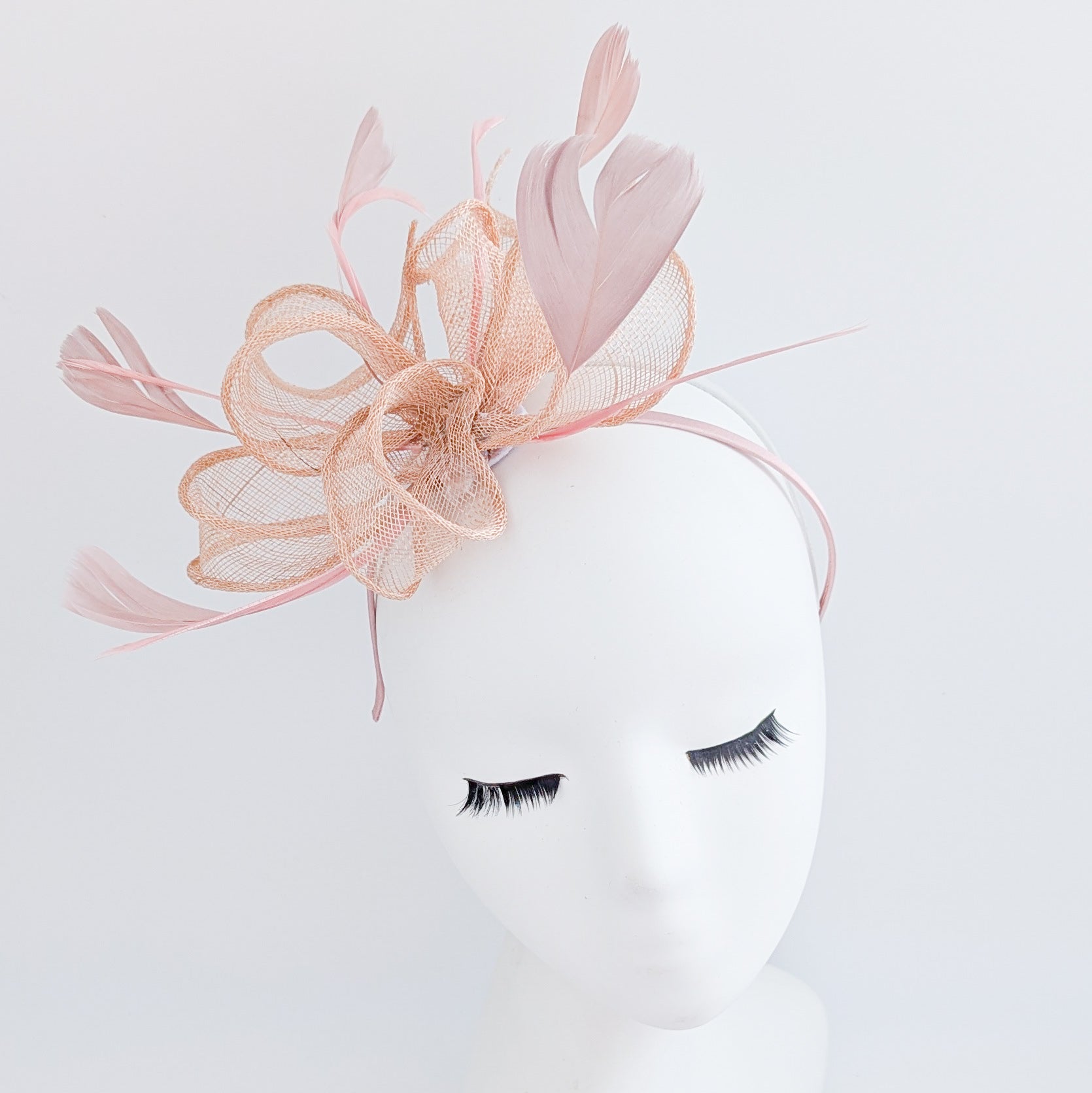 Light peach pink feather fascinator hat Light peach pink feather fascinator hat