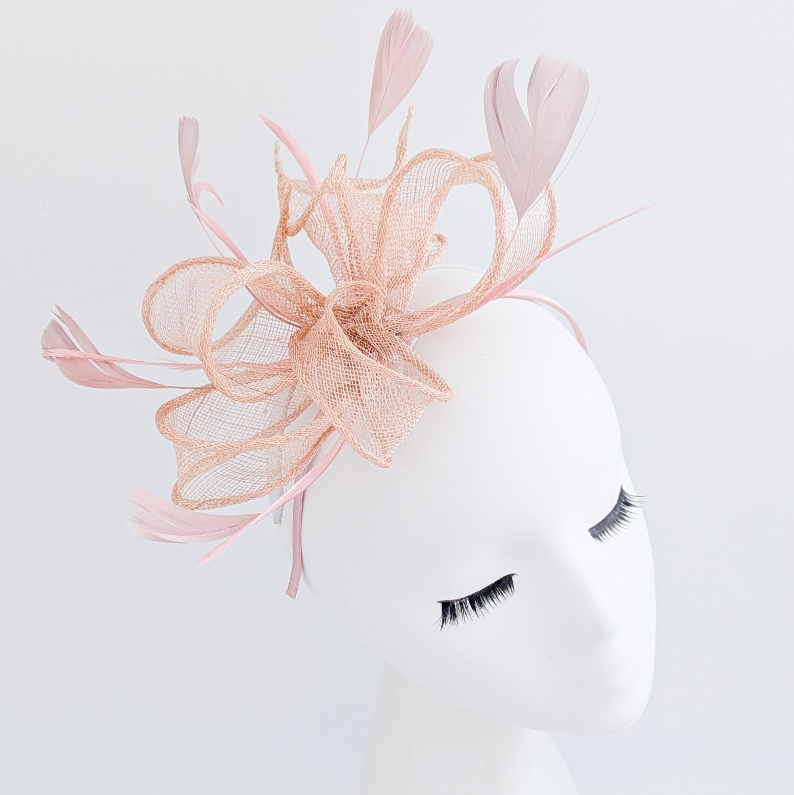 Light peach pink feather fascinator hat Light peach pink feather fascinator hat