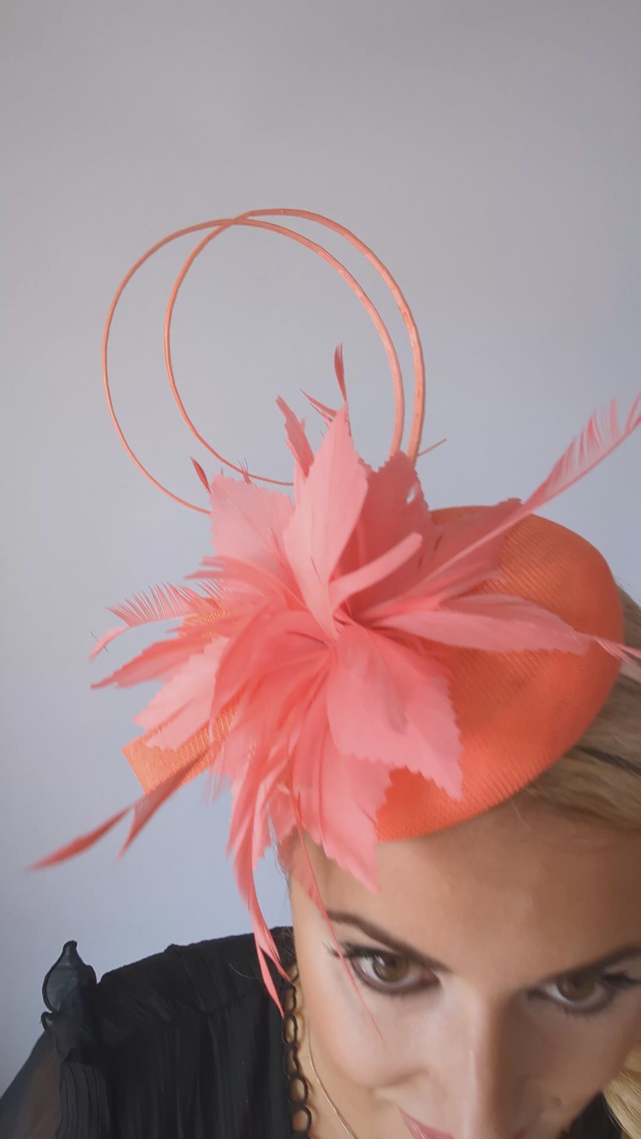 Coral orange feather fascinator hat Coral orange feather fascinator hat