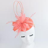 Coral orange feather fascinator hat