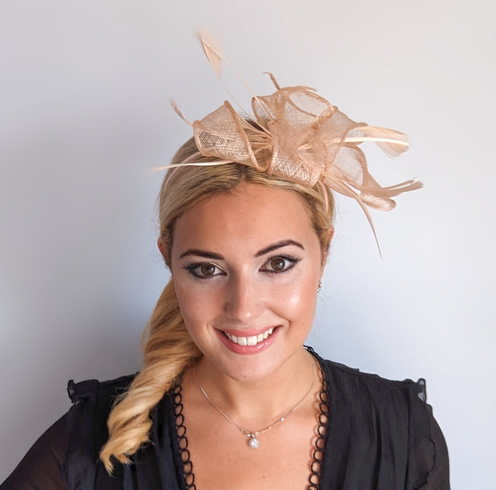 Light peach pink feather fascinator hat