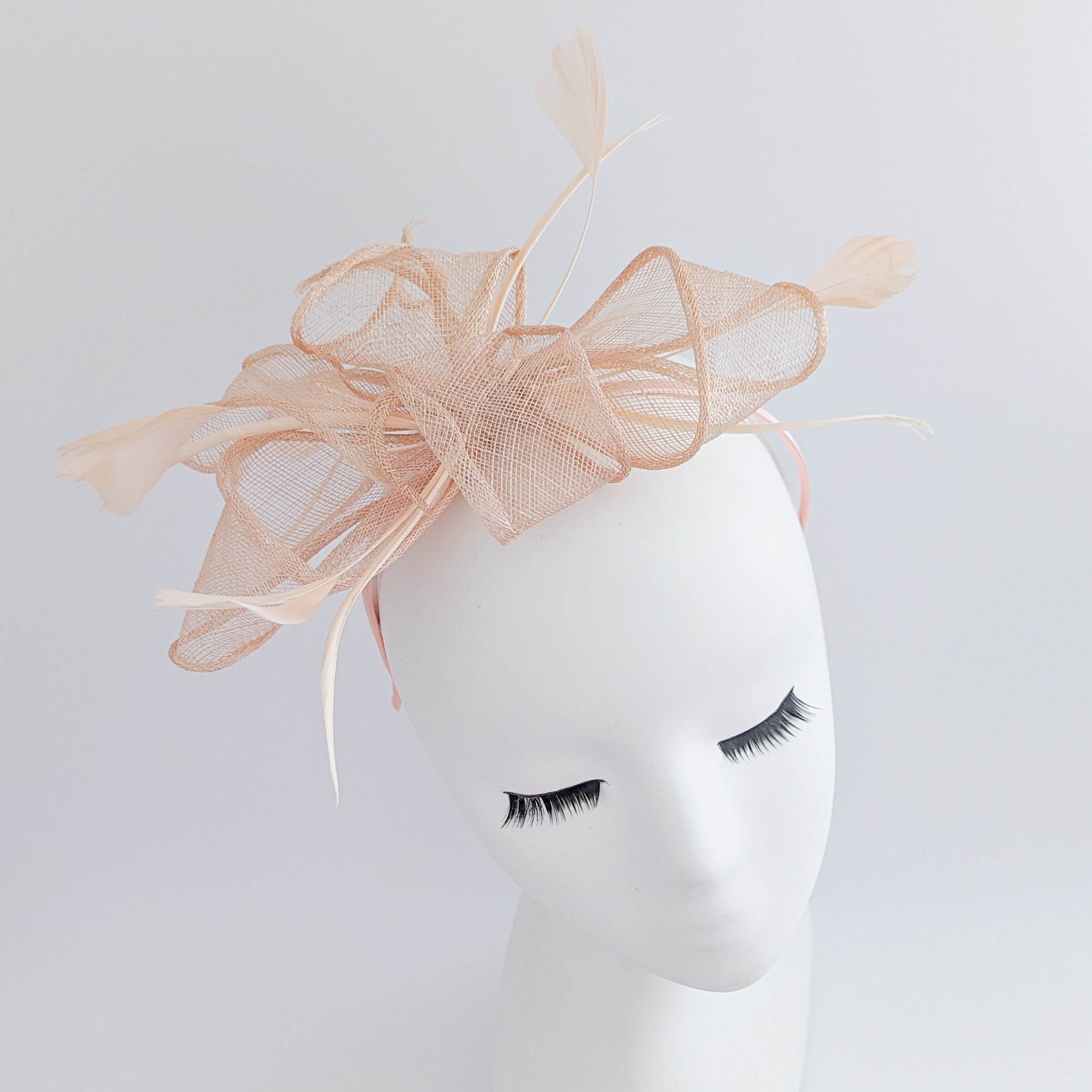 Light peach pink feather fascinator hat