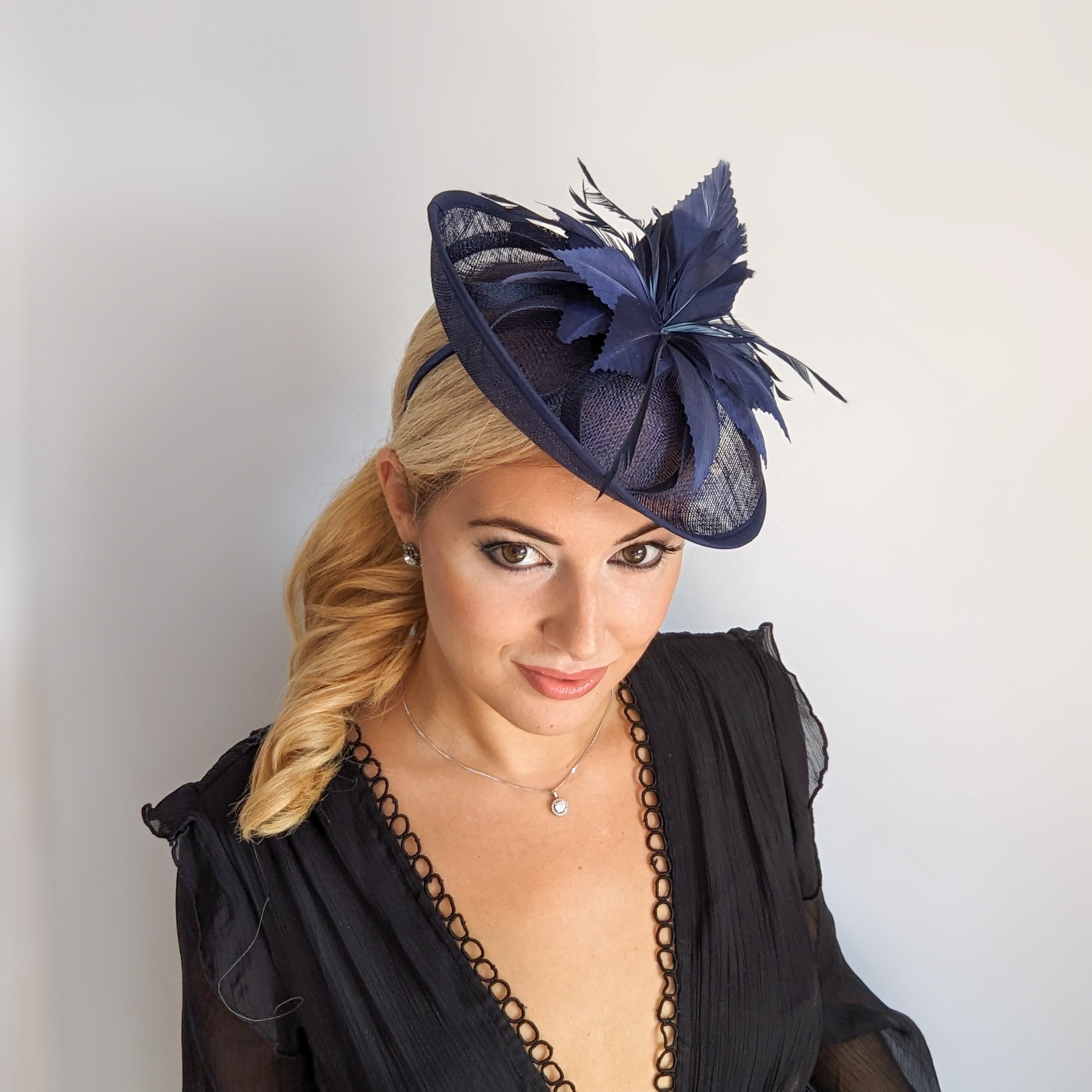 Navy blue feather disc saucer fascinator hat