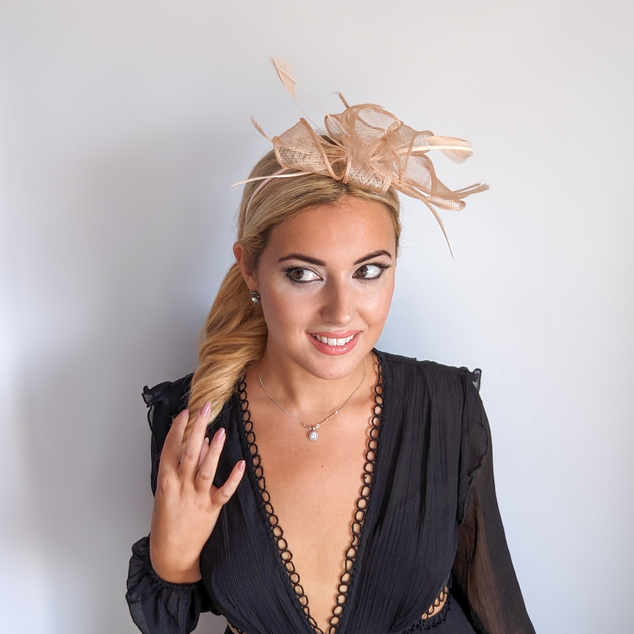 Light peach pink feather fascinator hat