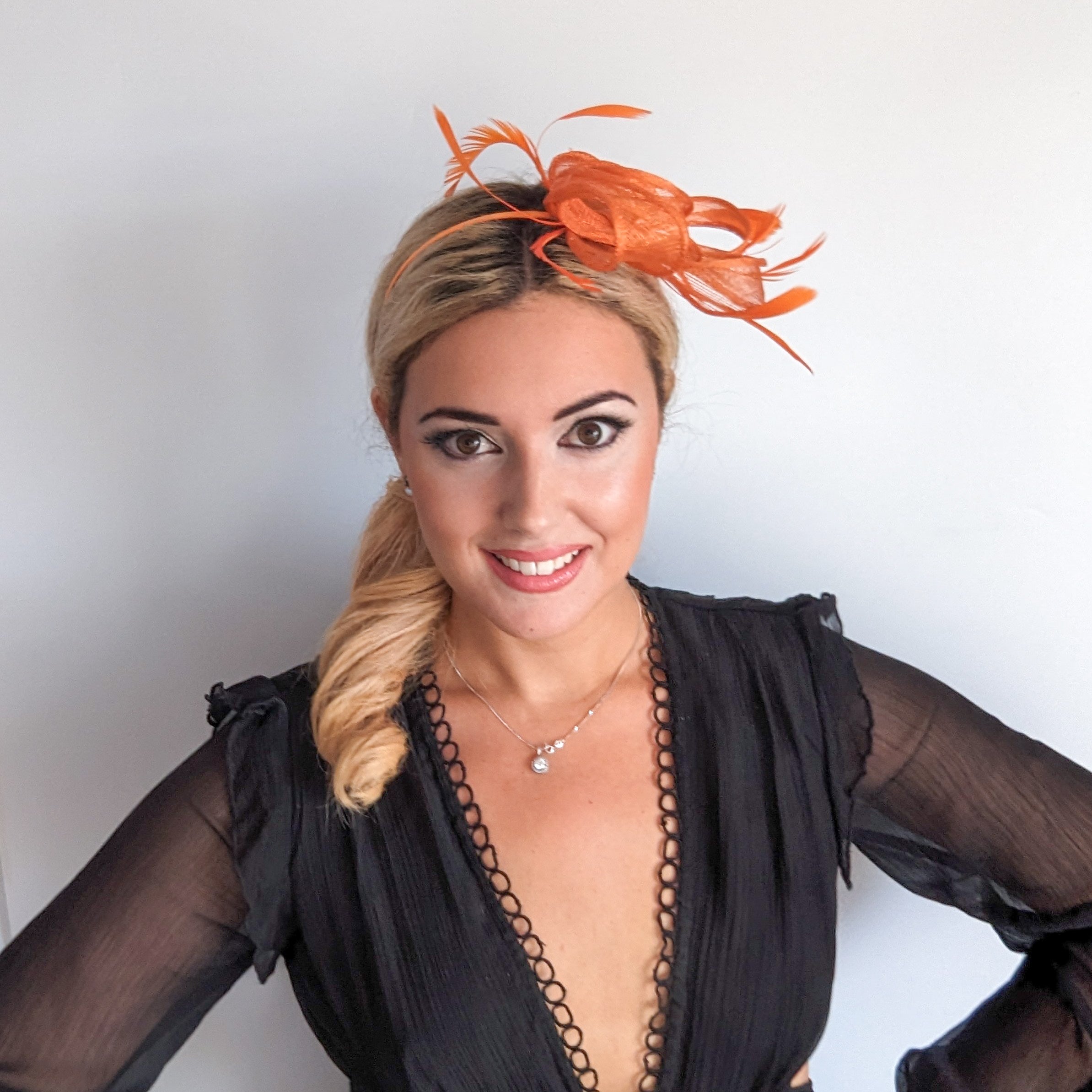 Orange feather fascinator hat