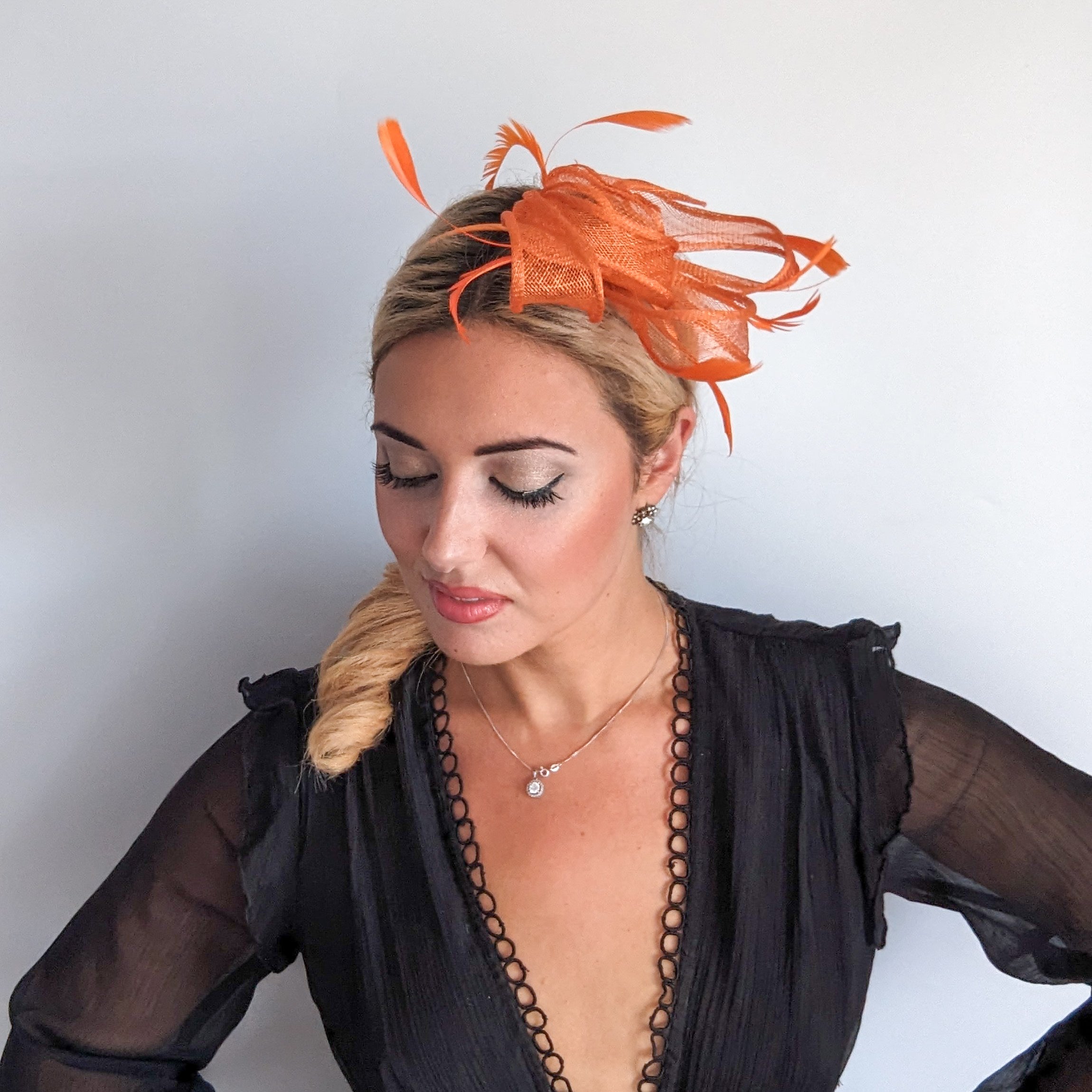 Orange feather fascinator hat