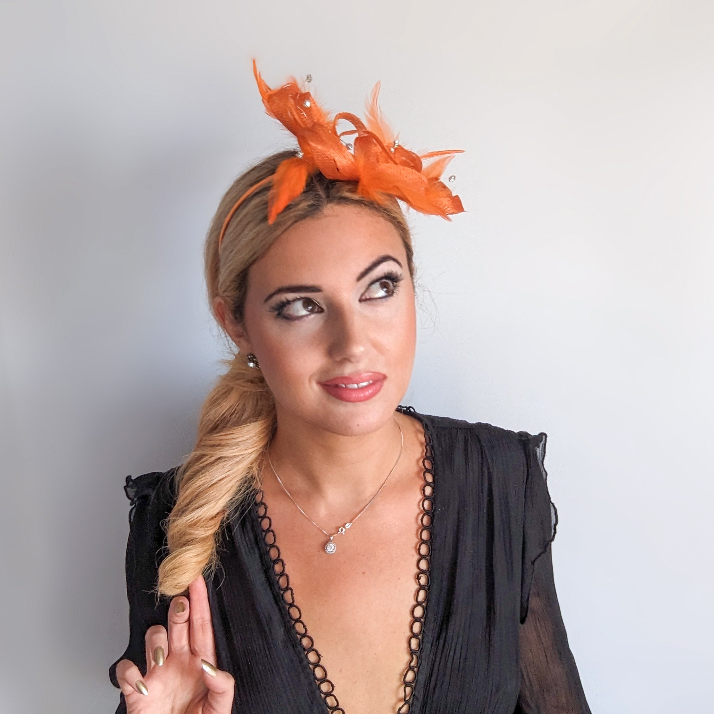 Orange crystal feather fascinator hat