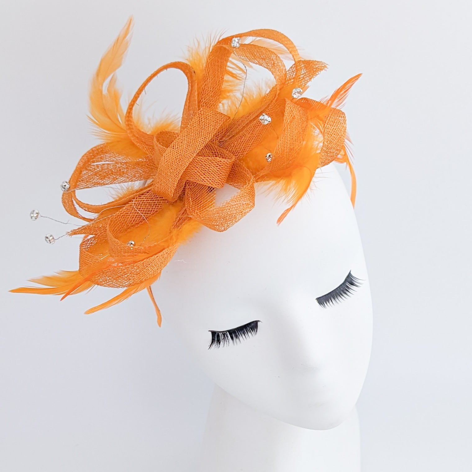 Orange crystal feather fascinator hat