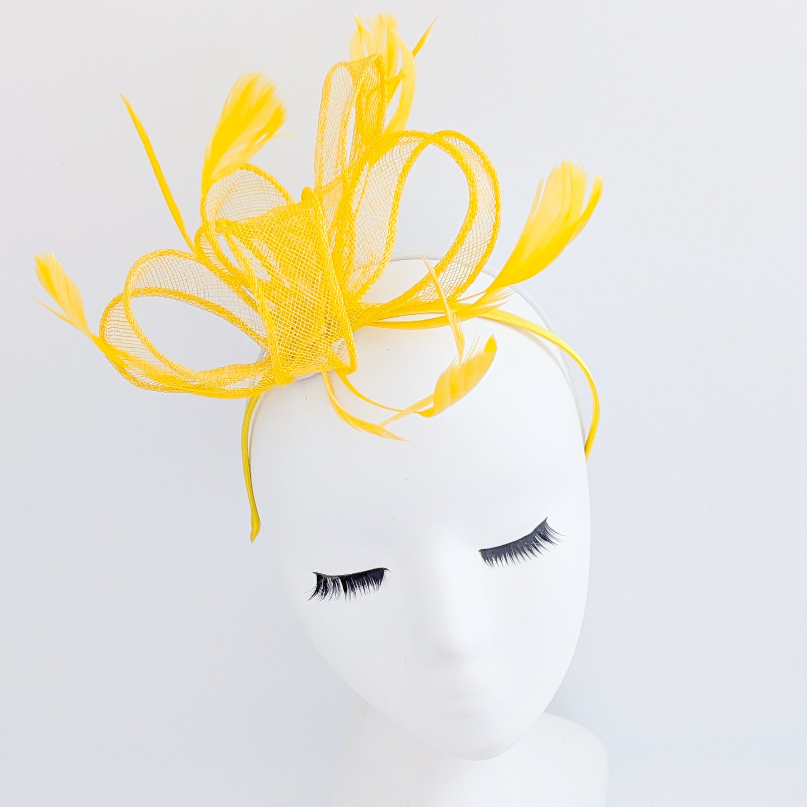 Yellow feather fascinator hat