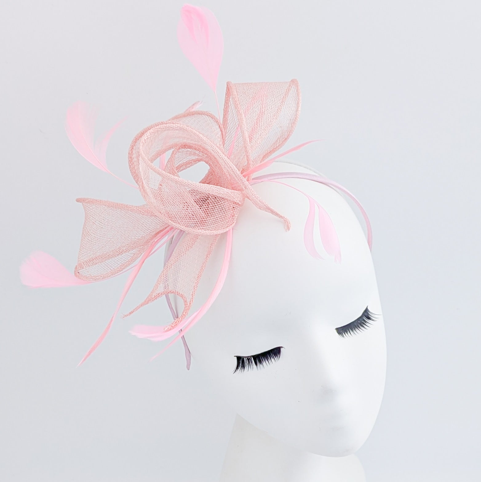 Light peach pink feather fascinator hat