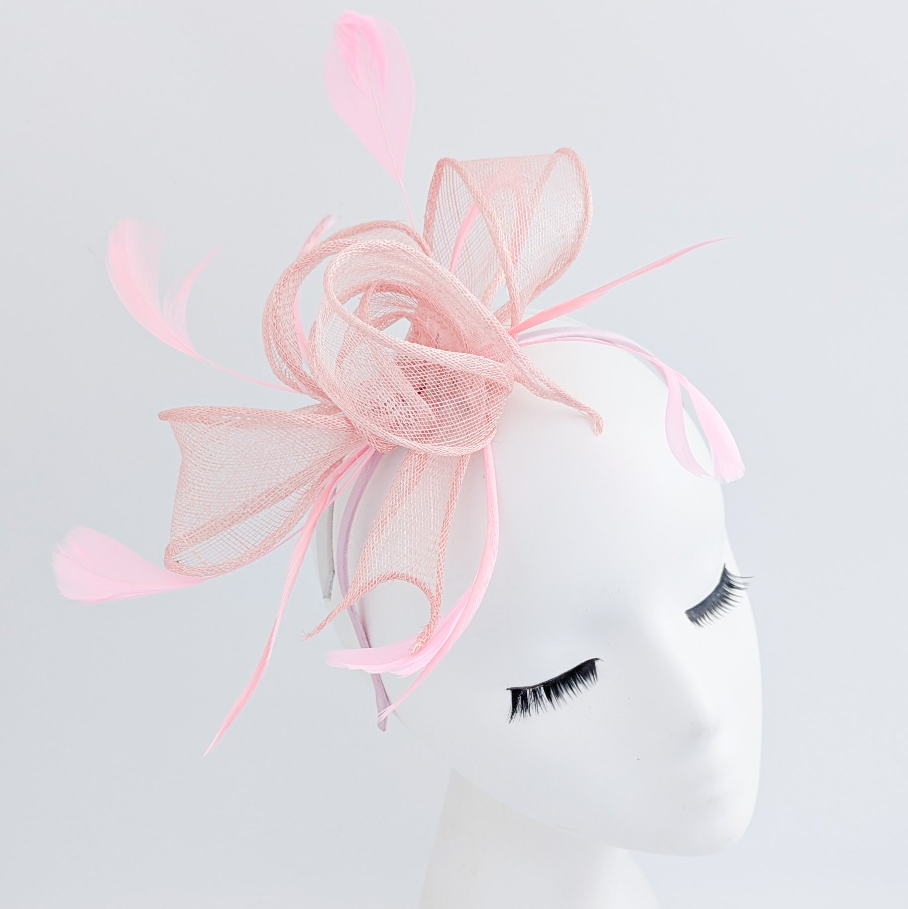 Light peach pink feather fascinator hat