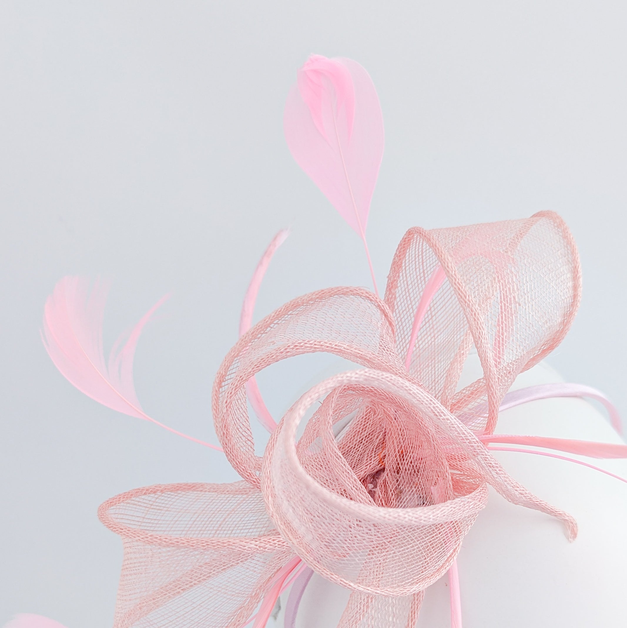 Light peach pink feather fascinator hat
