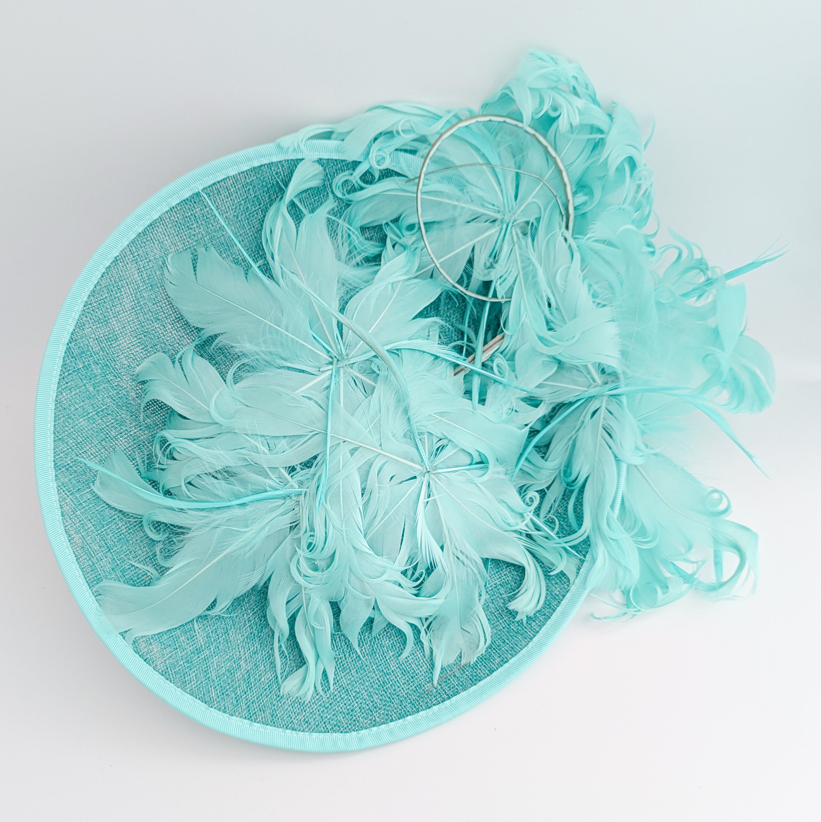 Light turquoise green blue large feather saucer disc fascinator hat