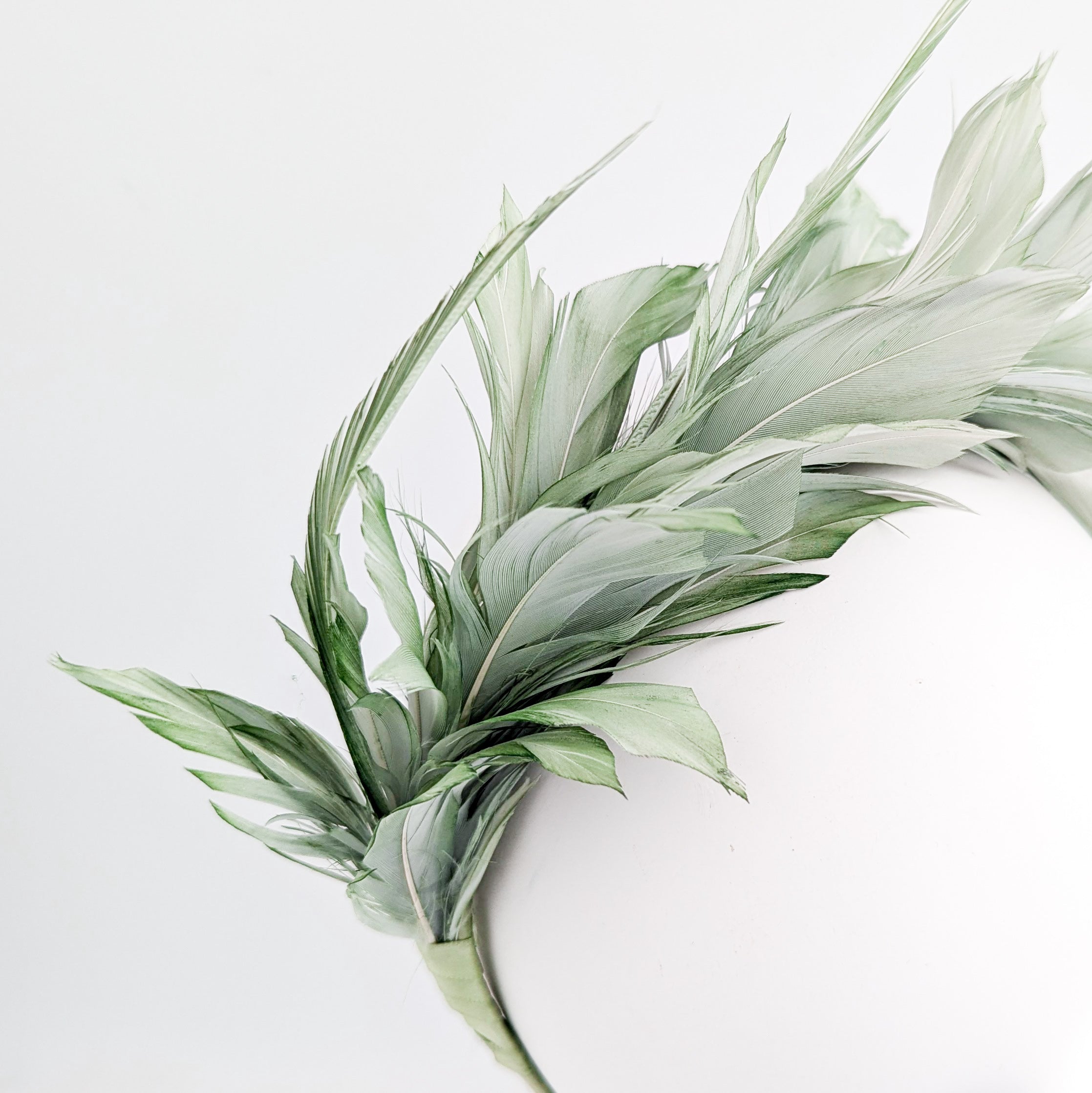Sage green feather satin headband fascinator