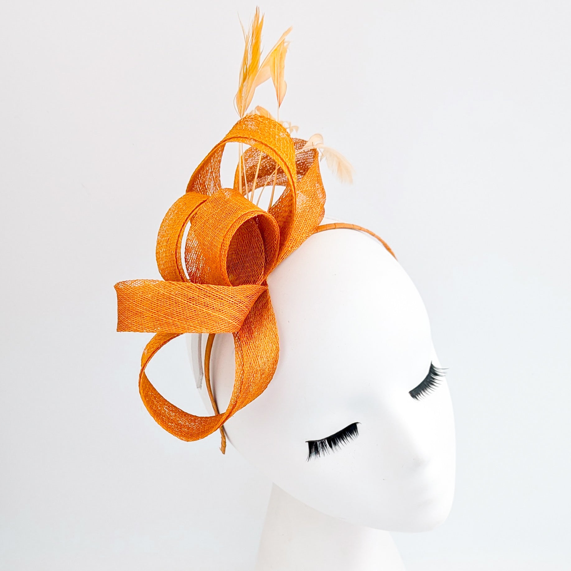 Burnt orange feather fascinator hat