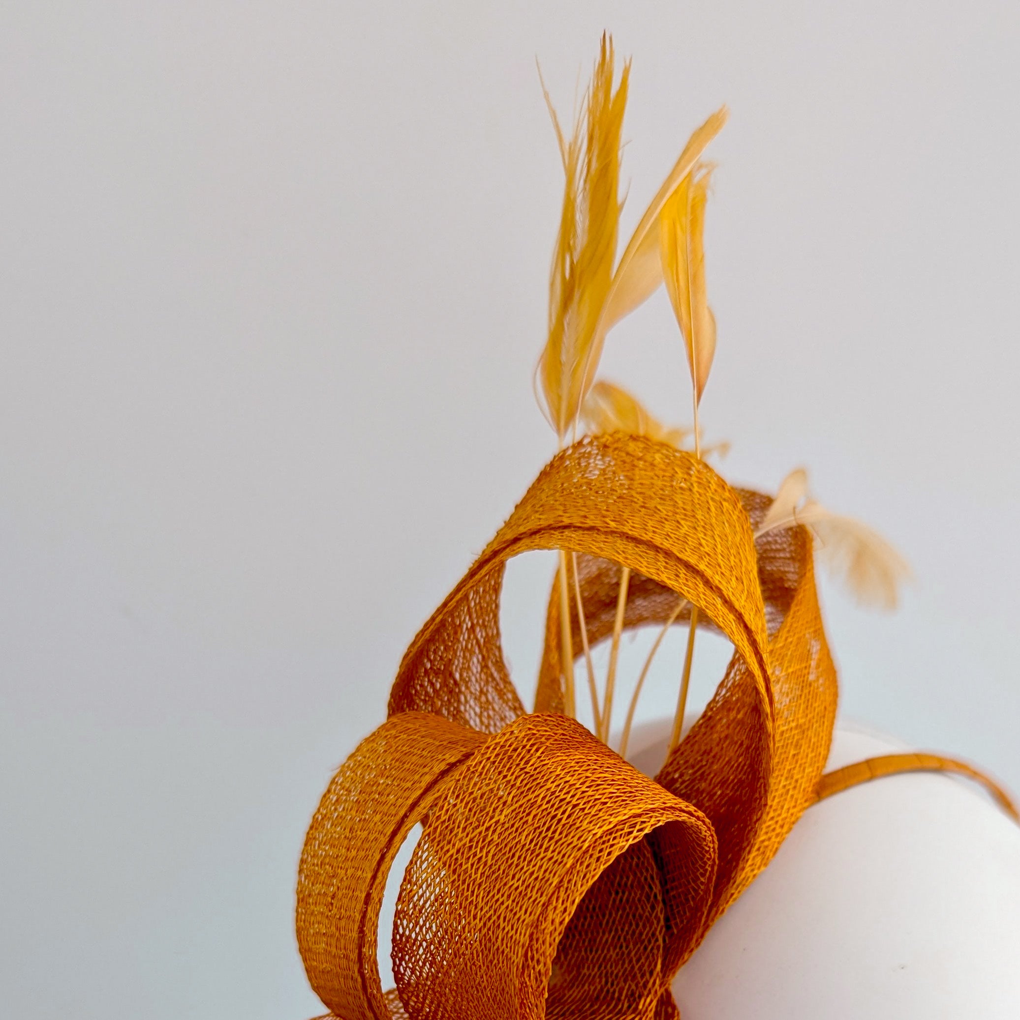 Burnt orange feather fascinator hat