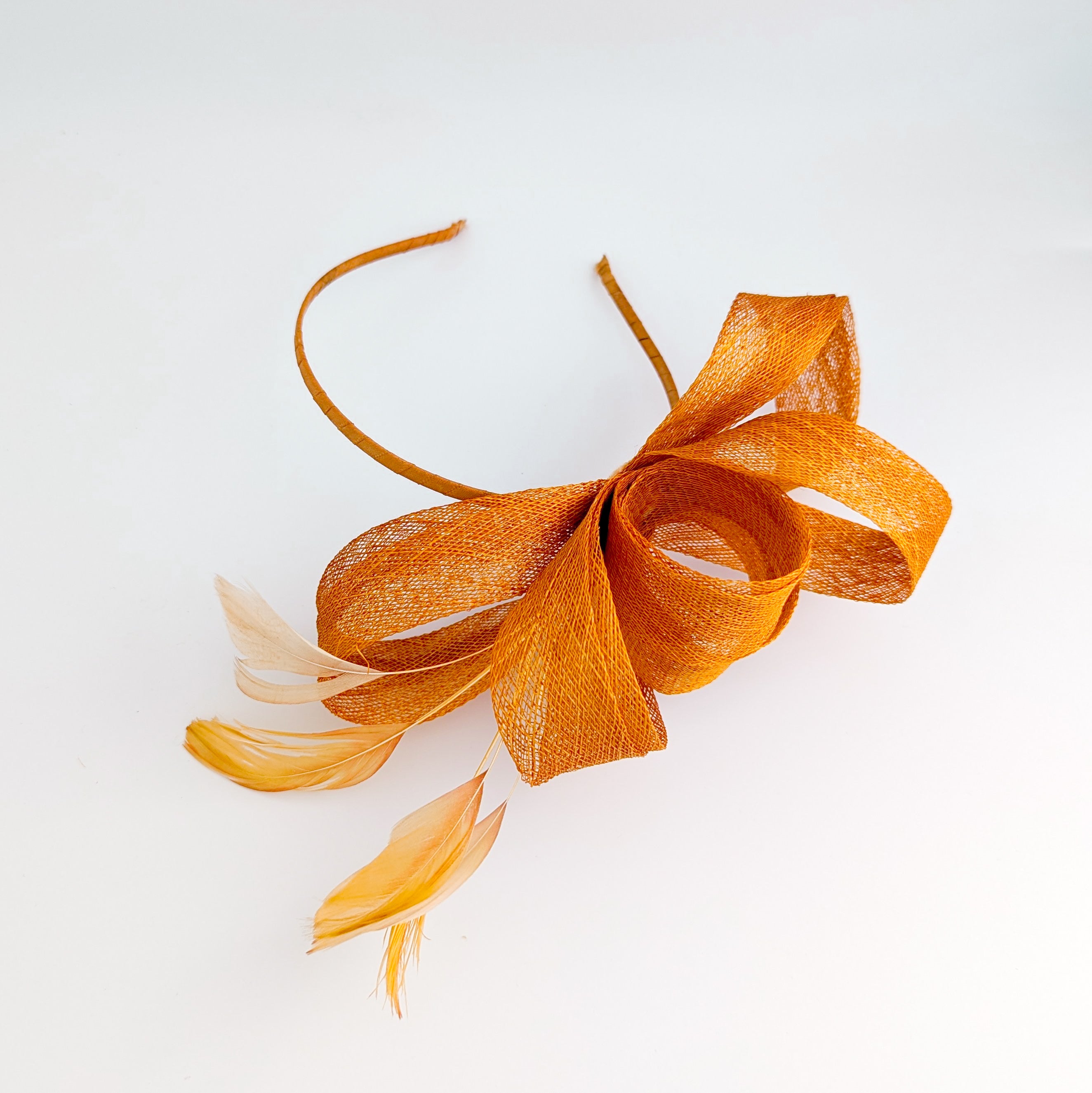 Burnt orange feather fascinator hat