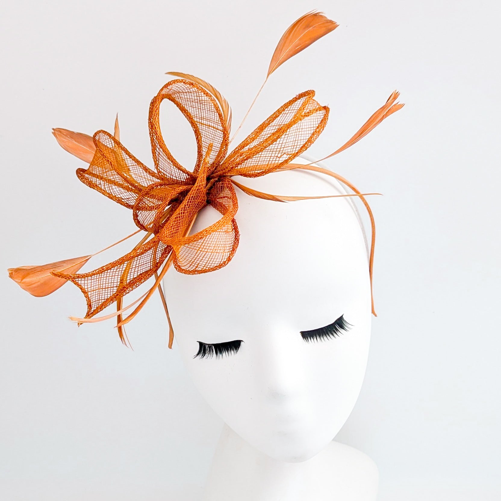 Burnt orange feather fascinator hat
