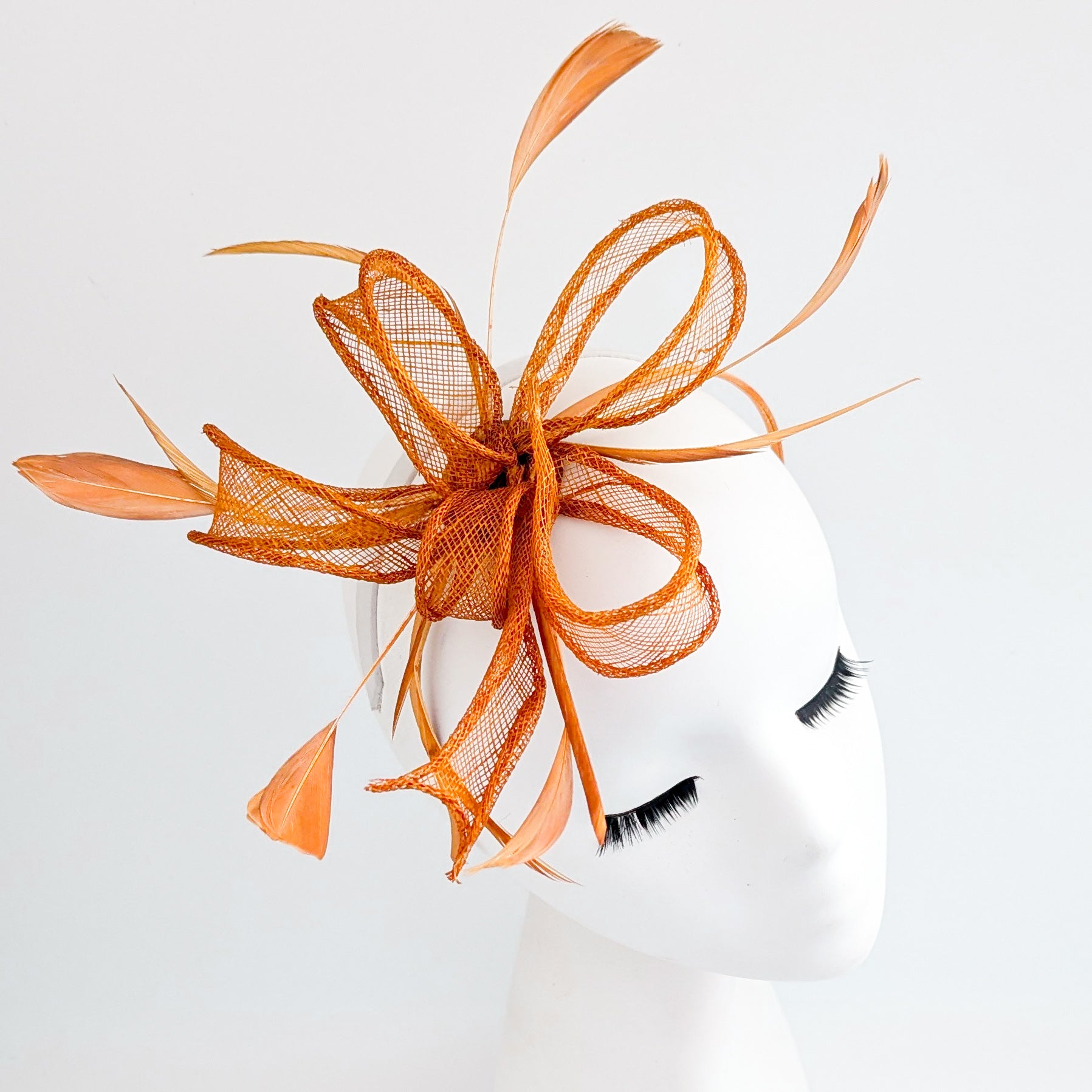 Burnt orange feather fascinator hat
