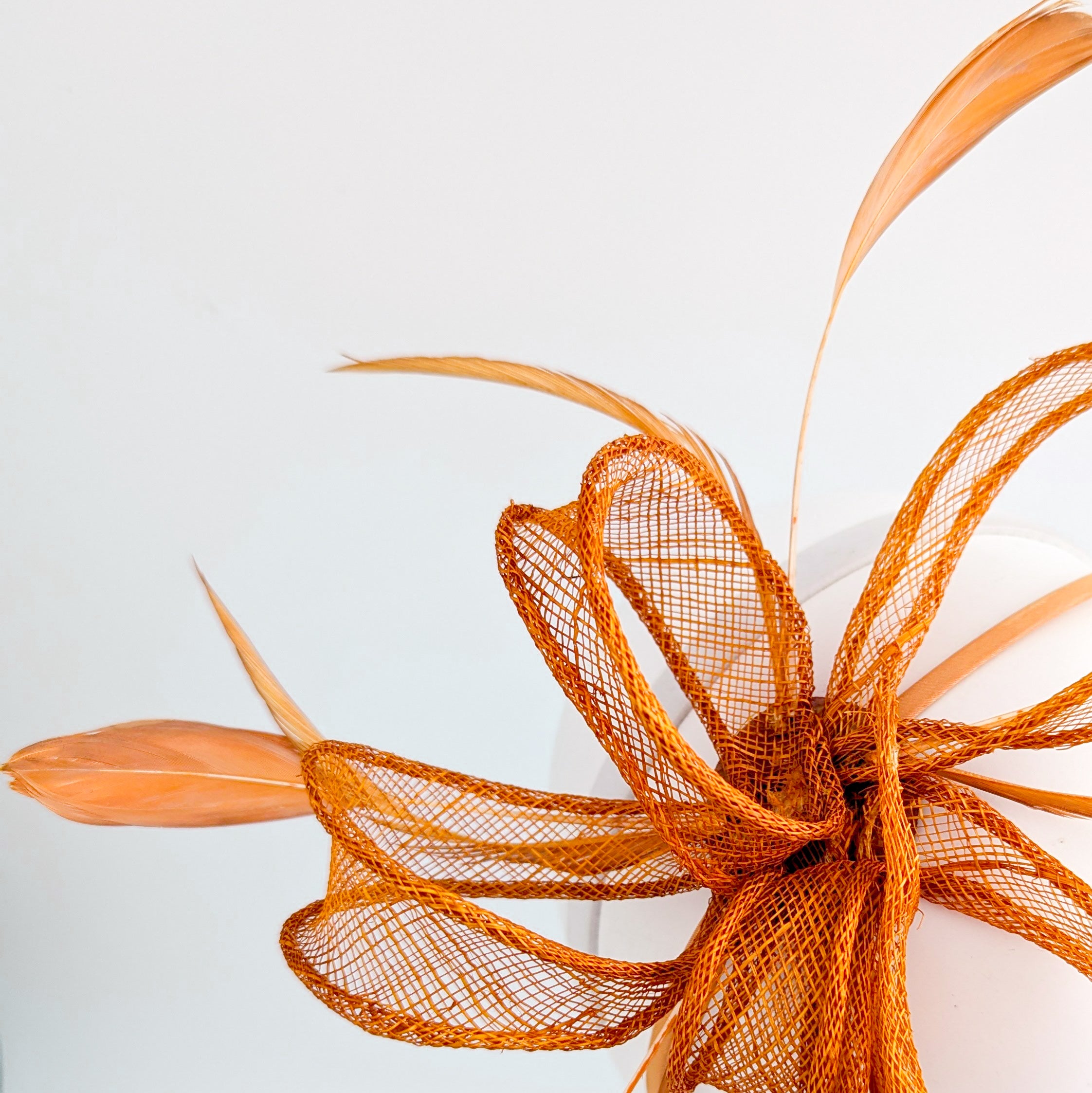 Burnt orange feather fascinator hat