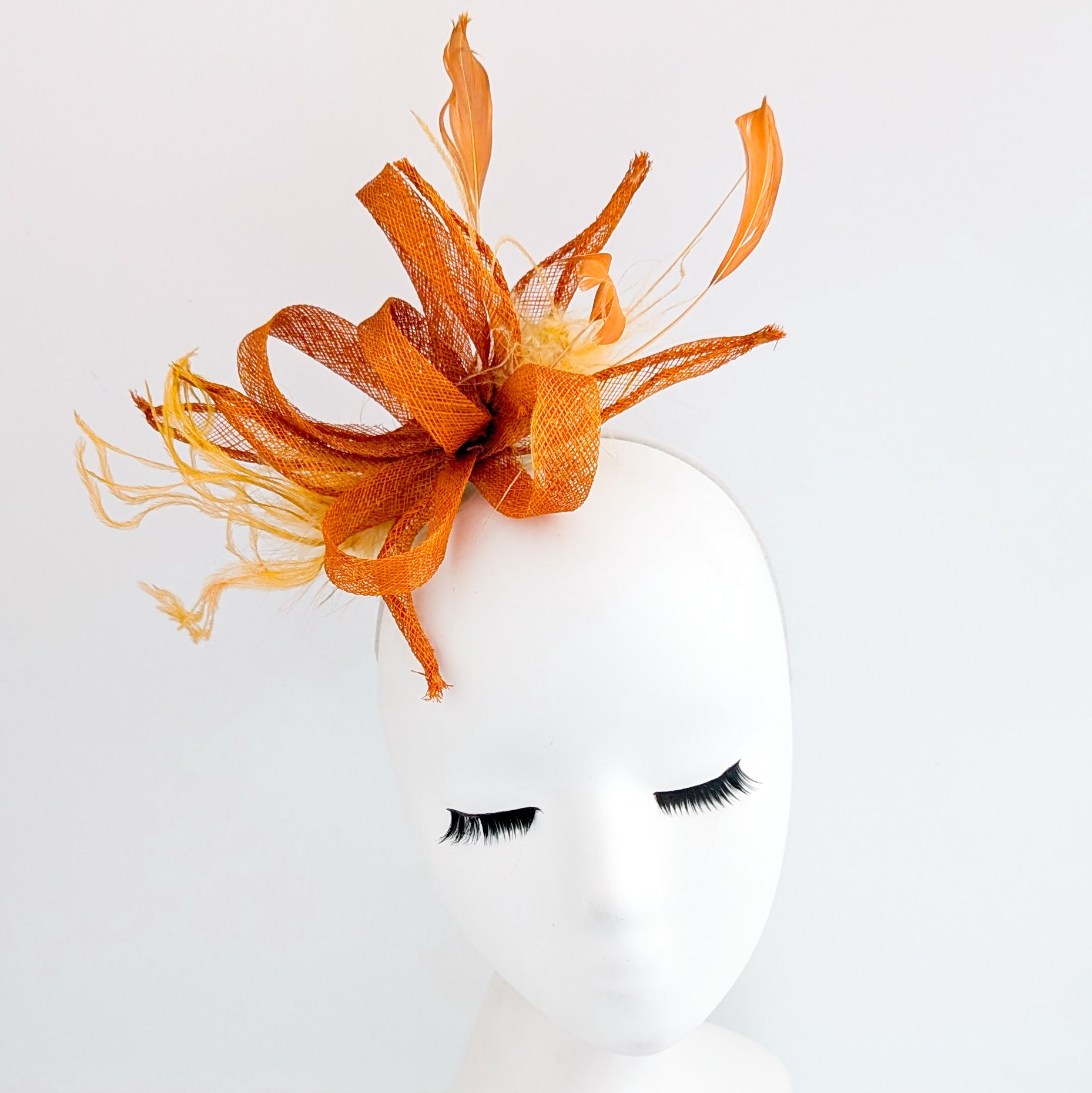 Burnt orange feather fascinator hat
