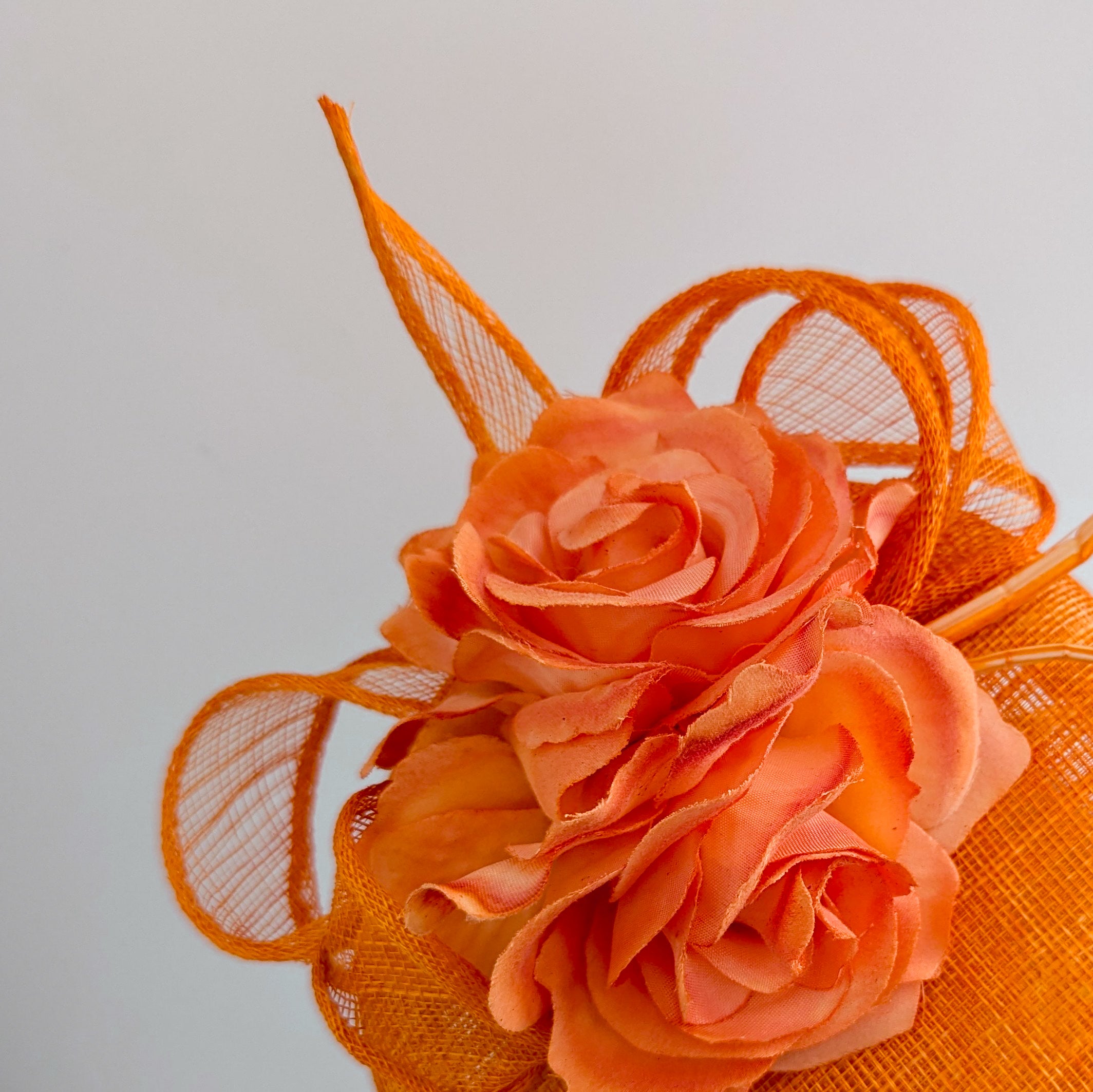 Bright orange coral flower fascinator hat