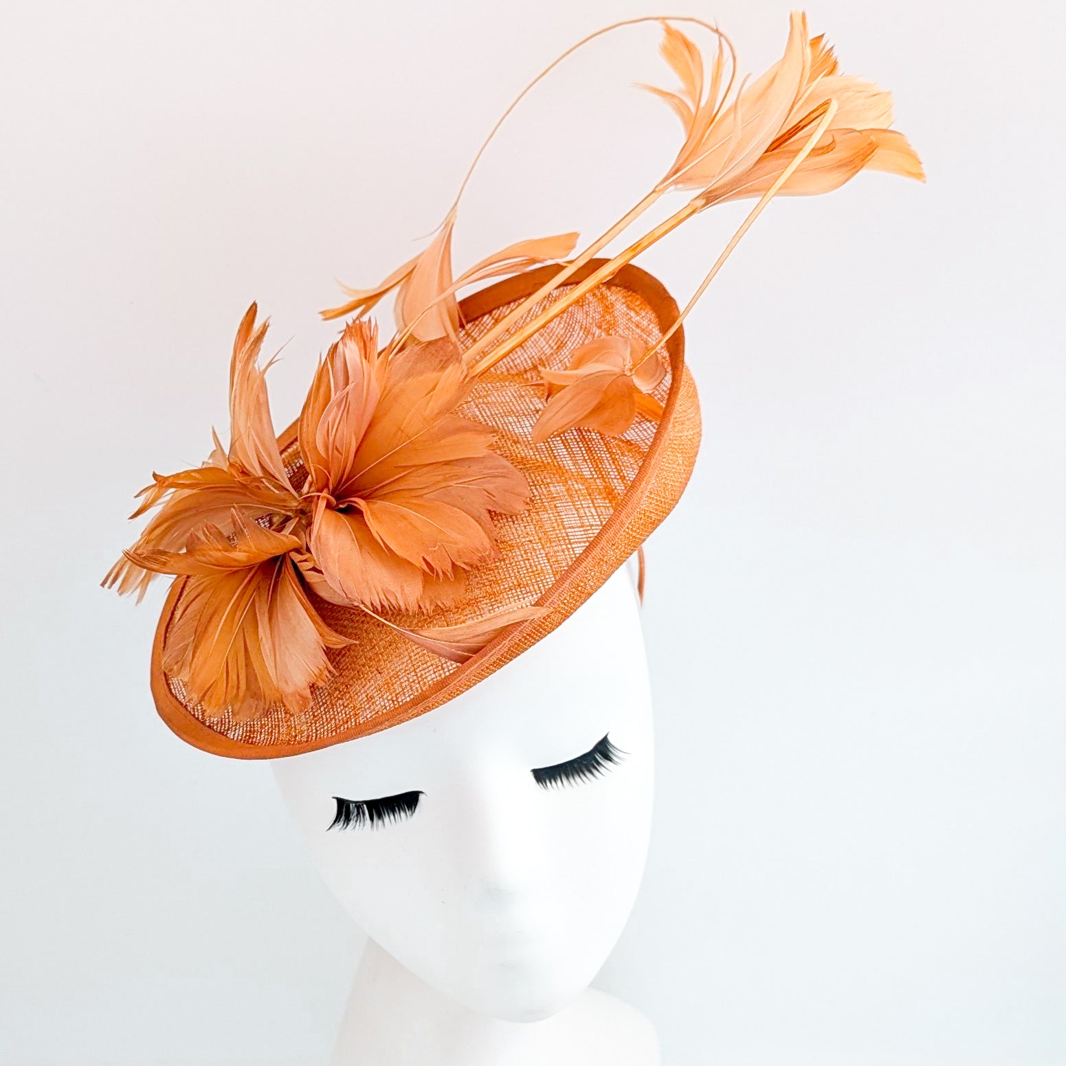 Dusty terracotta orange feather disc fascinator hat