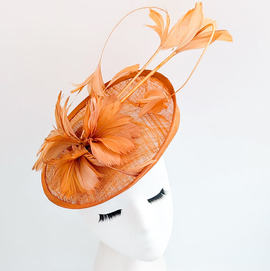 Dusty terracotta orange feather disc fascinator hat