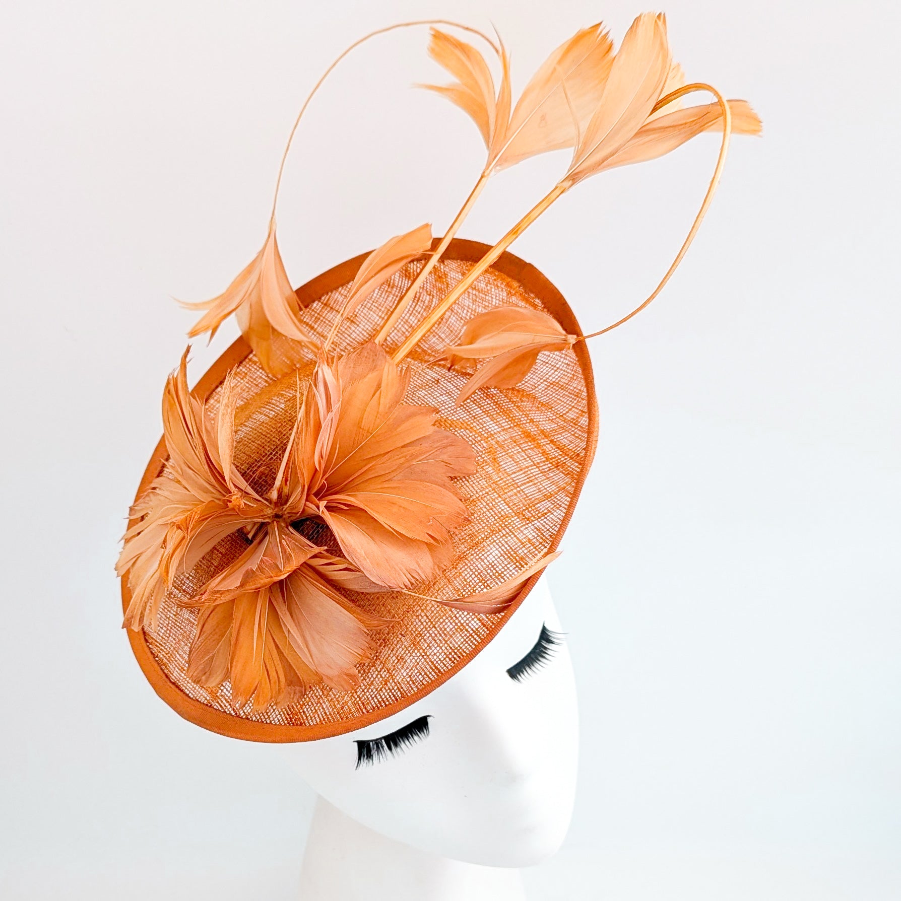 Dusty terracotta orange feather disc fascinator hat