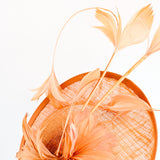 Dusty terracotta orange feather disc fascinator hat
