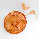Dusty terracotta orange feather disc fascinator hat