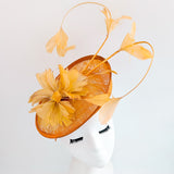 Tangerine orange feather disc fascinator hat