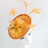 Tangerine orange feather disc fascinator hat