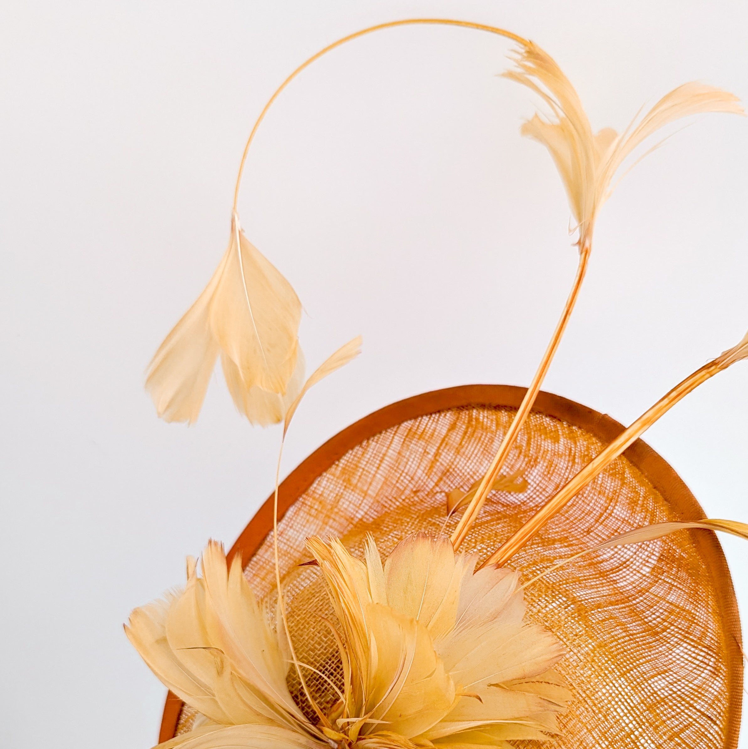 Tangerine orange feather disc fascinator hat