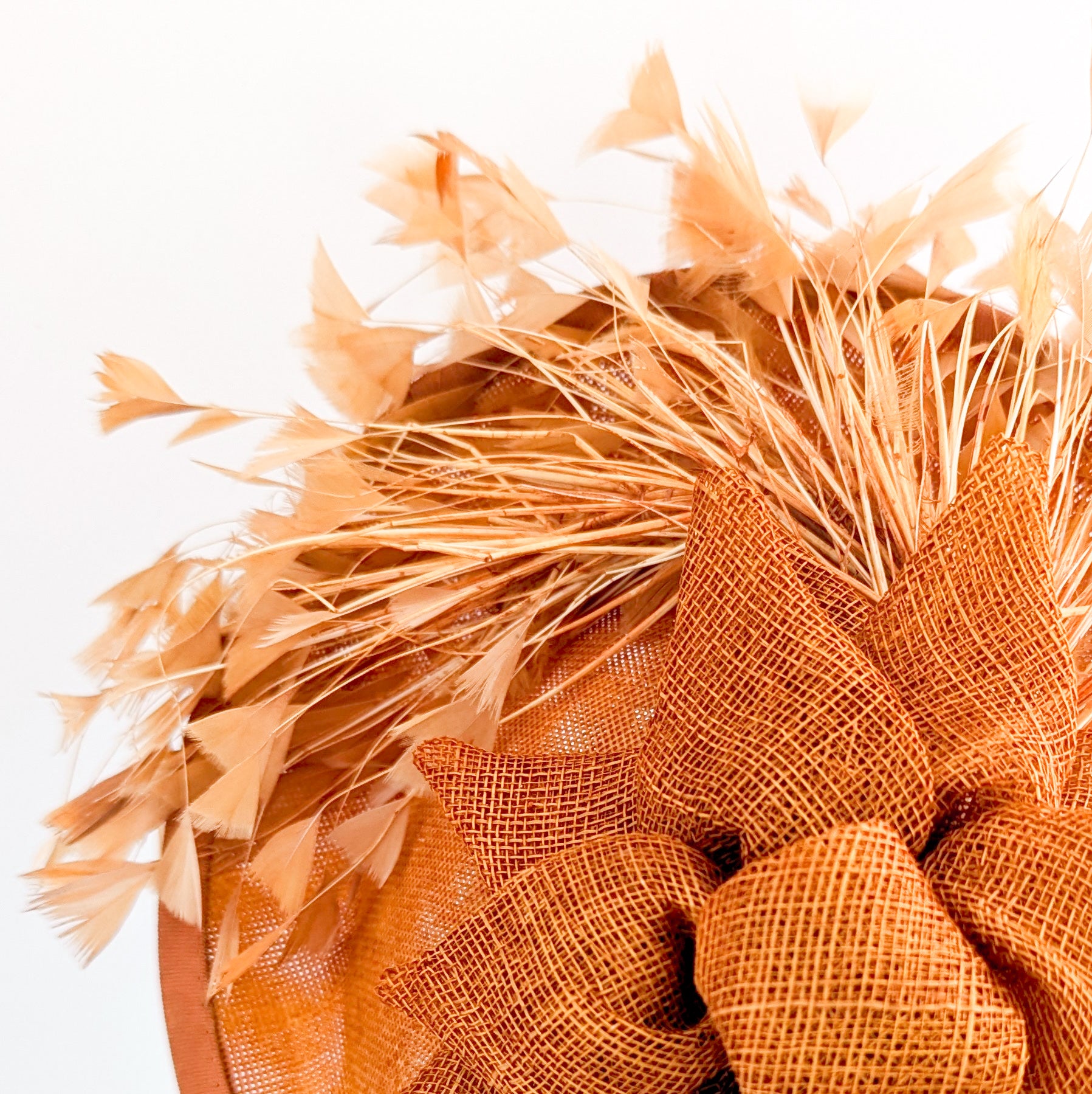 Burnt orange feather disc fascinator hat