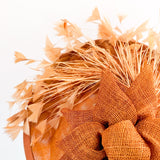 Burnt orange feather disc fascinator hat