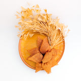 Tangerine orange feather disc fascinator hat