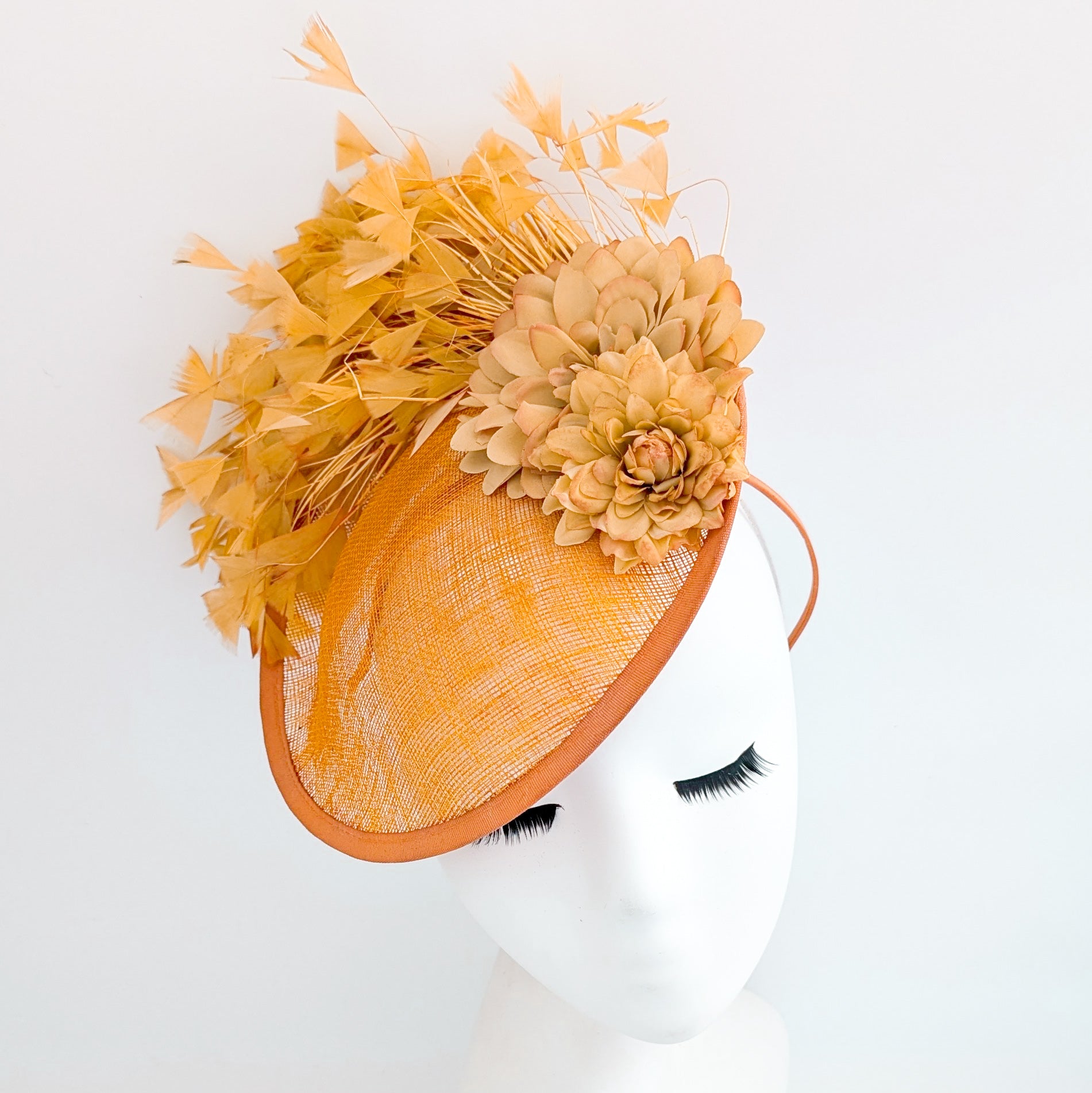 Tangerine orange flower feather disc fascinator hat