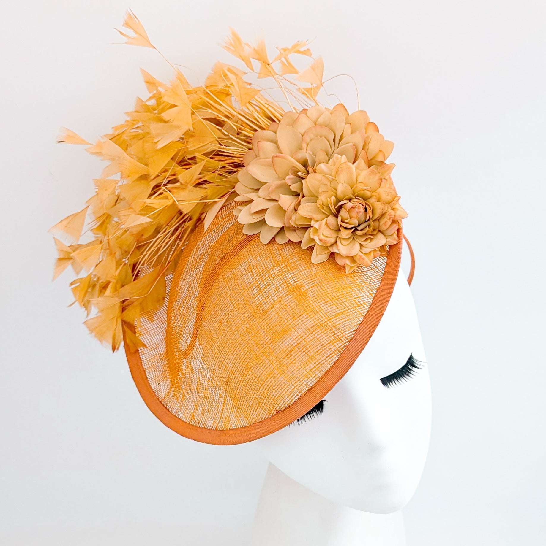Tangerine orange flower feather disc fascinator hat